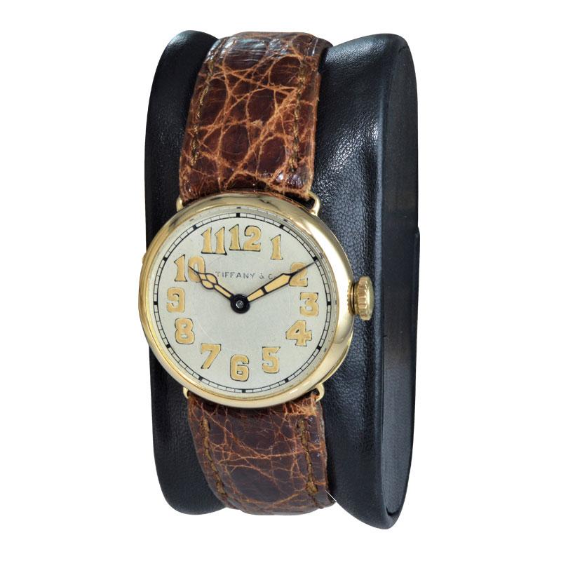 FACTORY / HOUSE: Tiffany & Co. by Longines Watch Company
STYLE / REFERENCE: Campaign Style / Art Deco 
METAL / MATERIAL: 18KT Yellow Gold
CIRCA / YEAR: 1917
DIMENSIONS / SIZE: 27mm X 28mm
MOVEMENT / CALIBER: Manual Winding / 15 Jewels 
DIAL / HANDS: