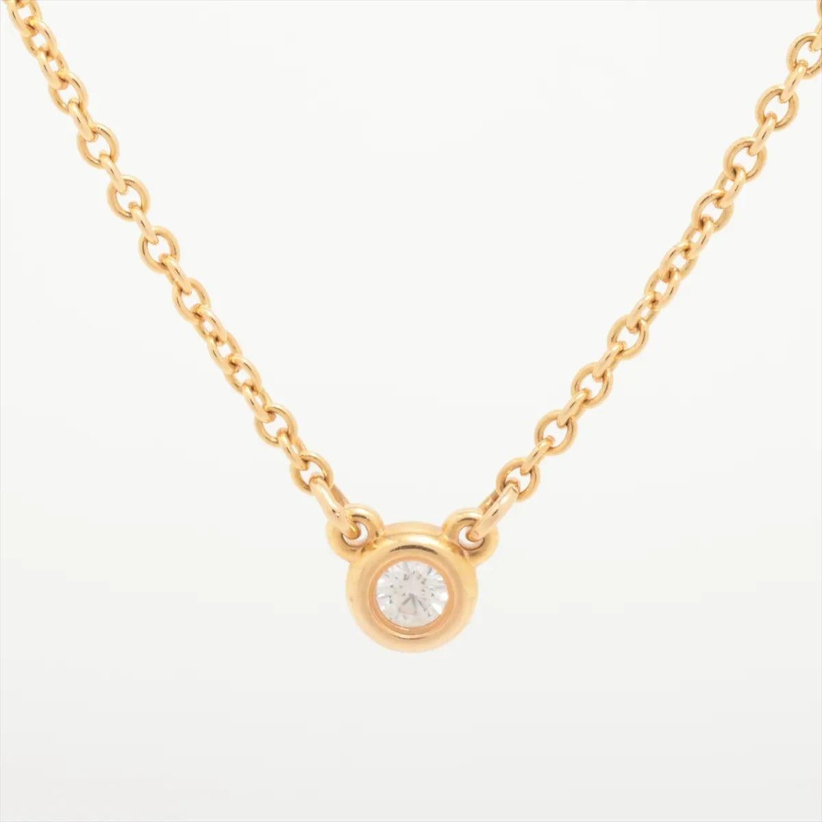 The Tiffany & Co. By the Yard Diamond Necklace in yellow gold features a single bezel-set round brilliant diamond as its elegant centerpiece. Crafted in luminous 18k yellow gold, the delicate chain draws attention to the centrally placed diamond,