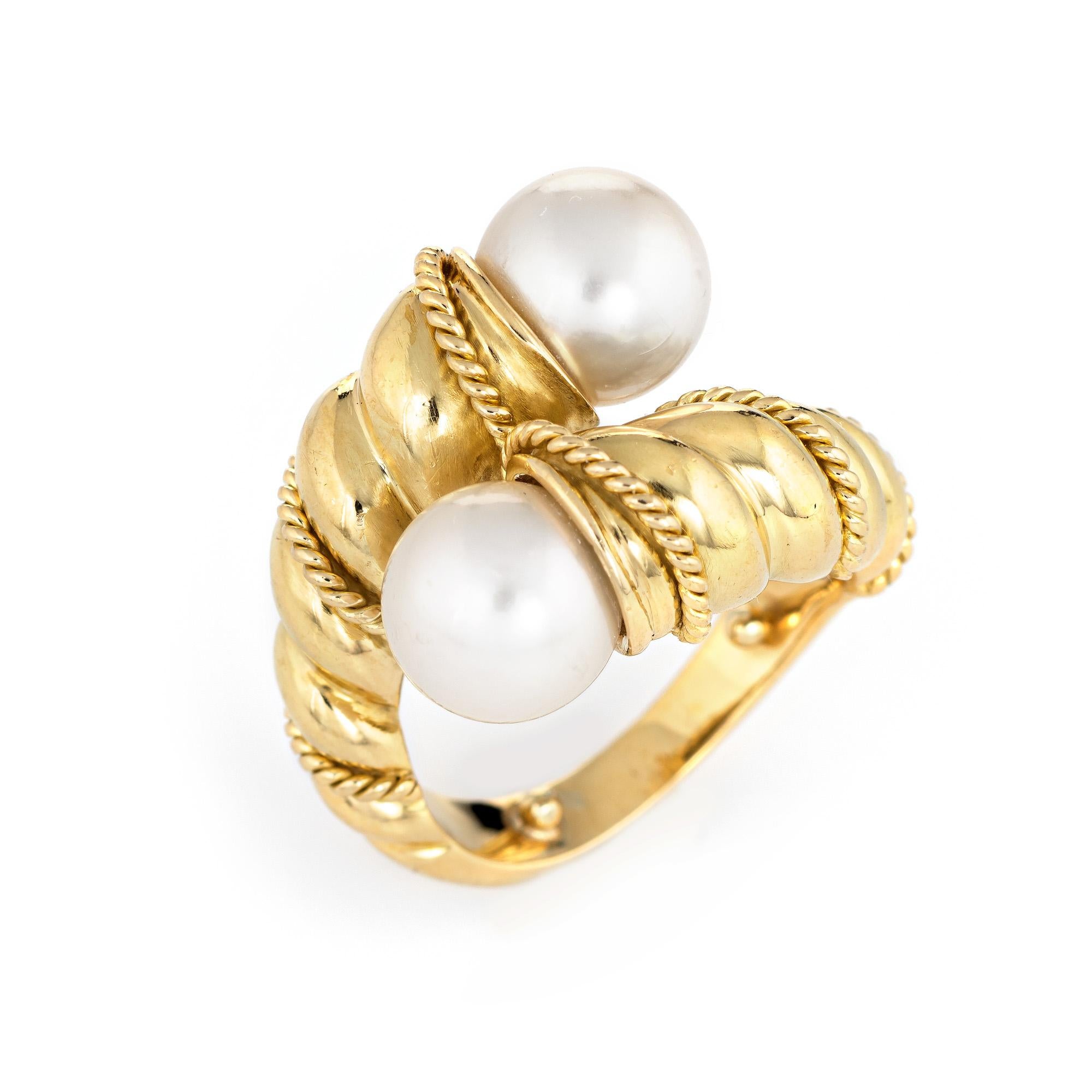 Finely detailed vintage Tiffany & Co cultured pearl bypass ring (circa 1990s) crafted in 18 karat yellow gold. 

Two cultured pearls each measure 8mm. The pearls are lustrous and show rose overtones.  

The stylish ring features a bypass design with