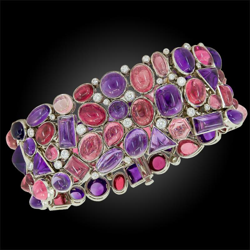A stunning bracelet by Tiffany & Co, crafted in platinum and 18k yellow gold, embellished with cabochon amethysts and pink tourmalines of various shapes, featuring round brilliant diamond accents.

Circa - 2000
Approx. -7 “ x  1 “
