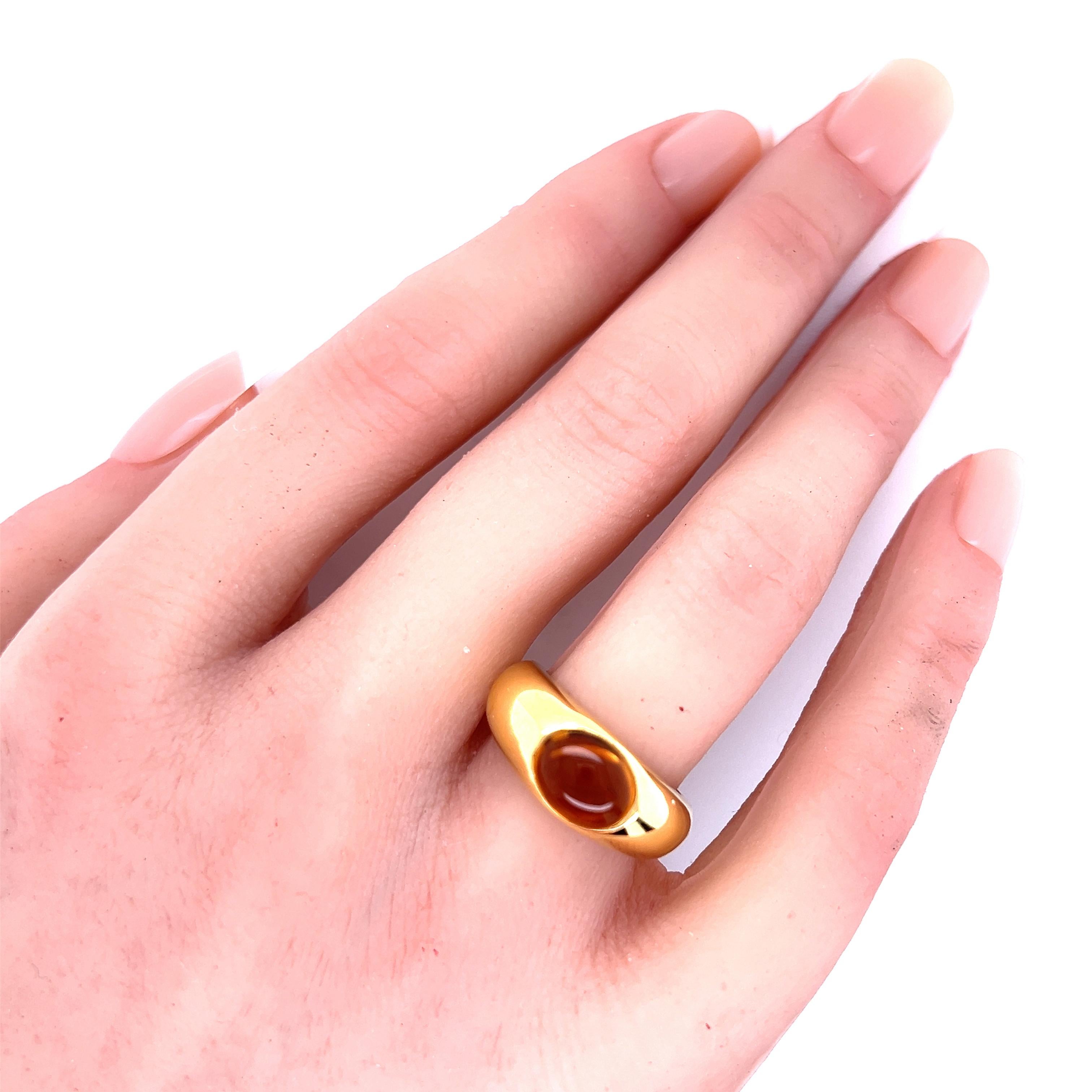 Crafted by the iconic Tiffany & Co., this Citrine Cabochon ring is a testament to elegance and fine craftsmanship. Set in 18k yellow gold, the dome-shaped design gracefully cradles the vibrant citrine stone, creating a piece that's both
