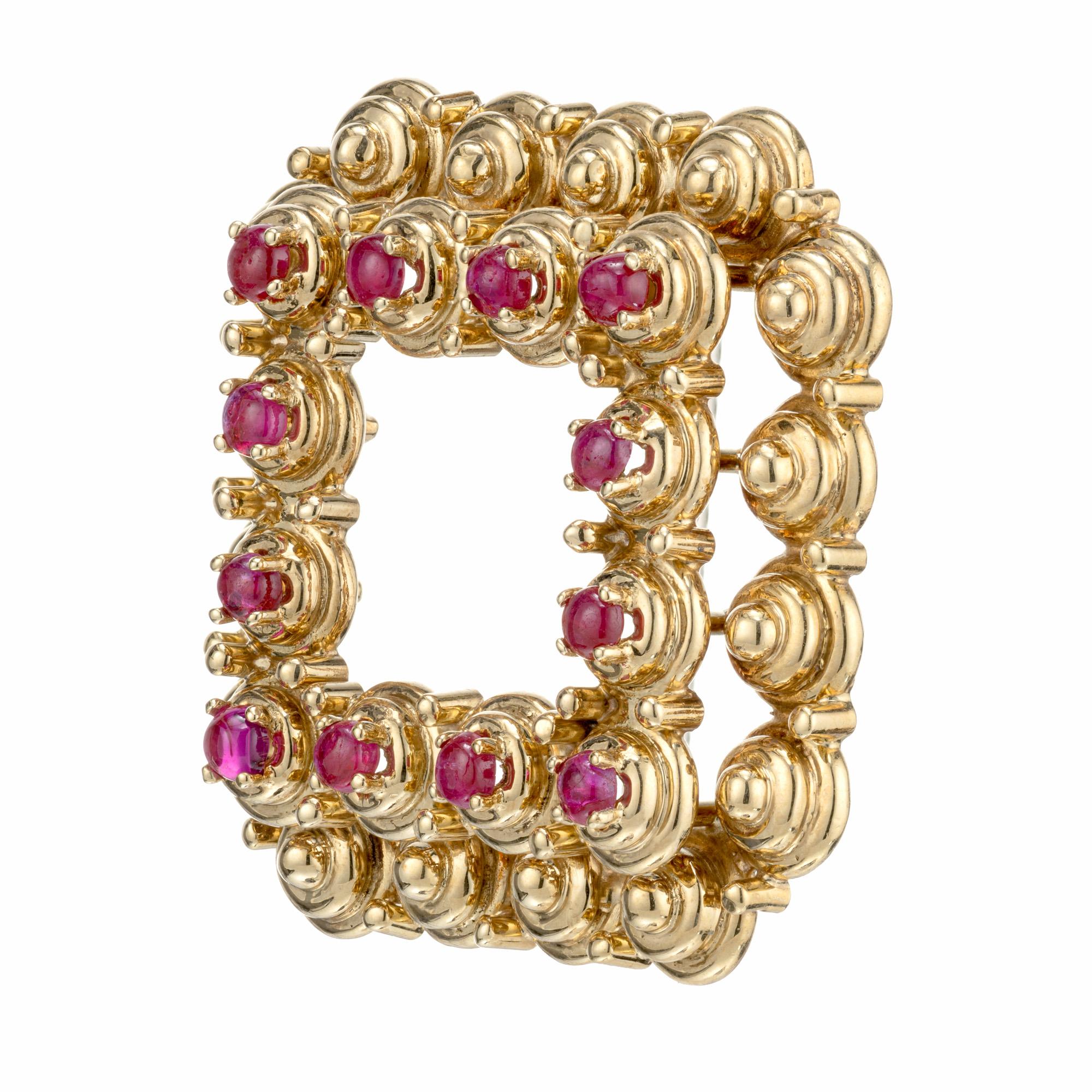 Tiffany & Co. ruby brooch. 12 round cabochon cut rubies in a square 18k yellow gold brooch. Circa 1950-1960.

12 2.5mm genuine natural cabochon Rubies, gem color
18k Yellow Gold
Stamped: Tiffany + Co 18k Italy
16.5 grams
Pin: 1.13 inches or 29mm