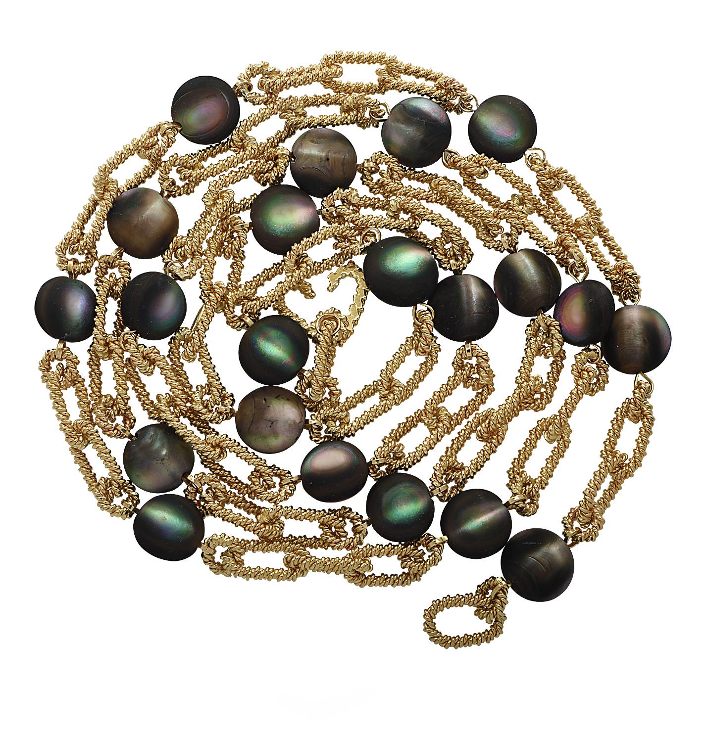 From the iconic House of Tiffany & Co. this vintage necklace, crafted in 18 karat yellow gold, features 21 sensational Cat’s Eye Labradorite cabochons. The necklace is fashioned from twisted yellow gold links interspersed with cat’s eye labradorite
