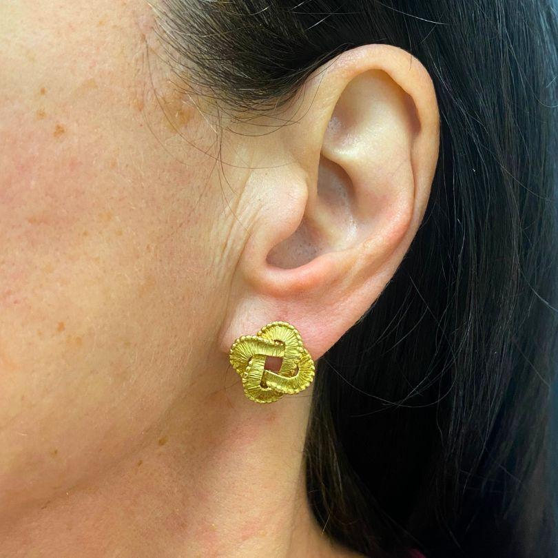 A pair of Tiffany & Co. Celtic knot 18k gold earrings.
The earrings feature a clean, sophisticated design with a detailed Celtic knot pattern that symbolizes connection and continuity. The textured finish and lightweight feel make these Tiffany