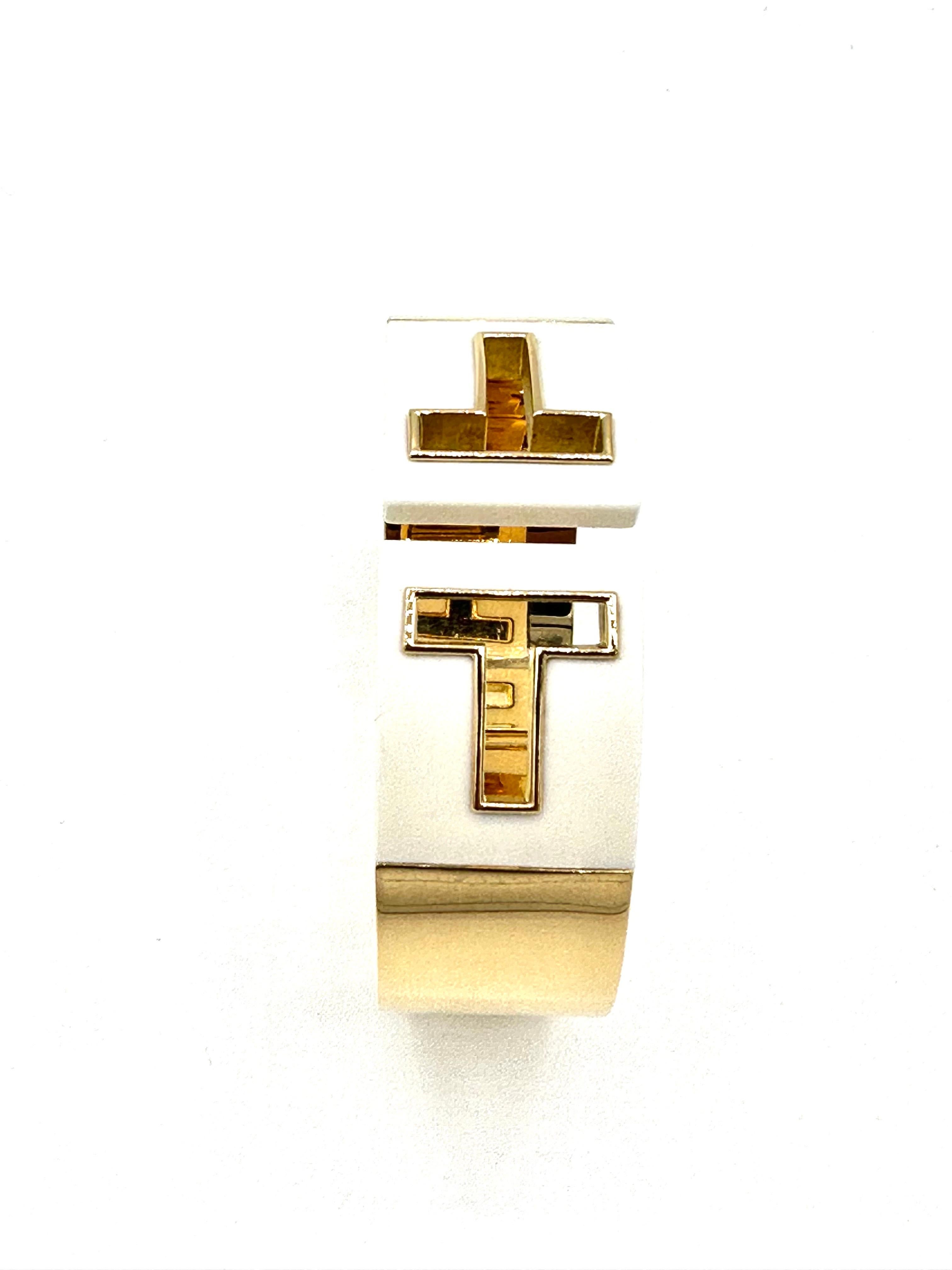 A fantastic easy to wear Tiffany & Co. hinged cuff bracelet.  The bracelet is made in all 18K yellow gold, and features a cut out 