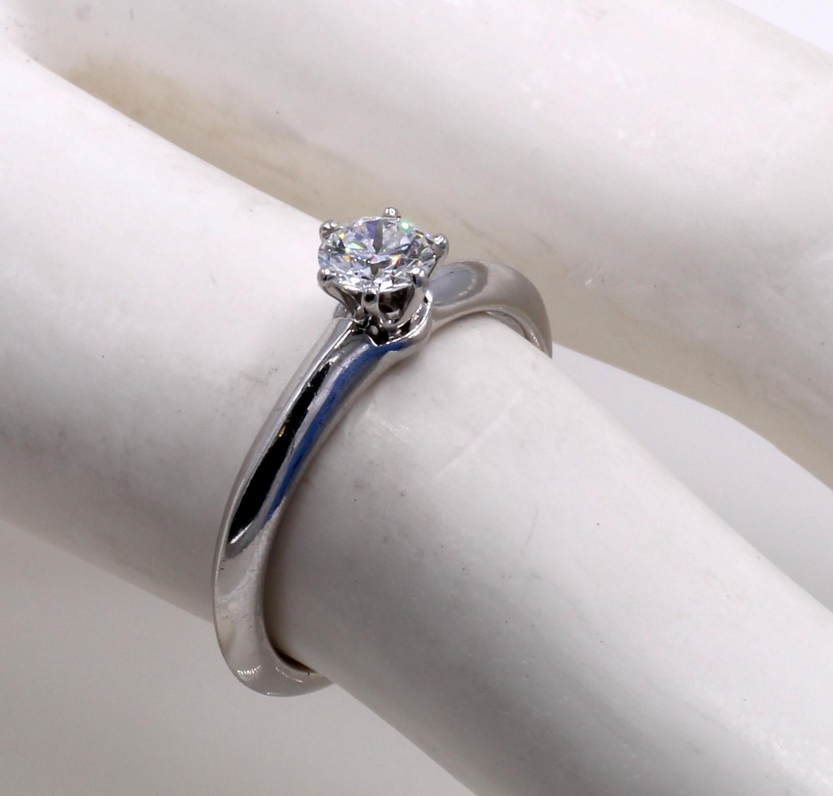 Platinum handcrafted ring by Tiffany & Co. featuring a perfect round brilliant cut diamond secured by 6 prongs. The central diamond is accompanied by a Tiffany certificate stating that the color is D and the clarity  IF - the highest color and