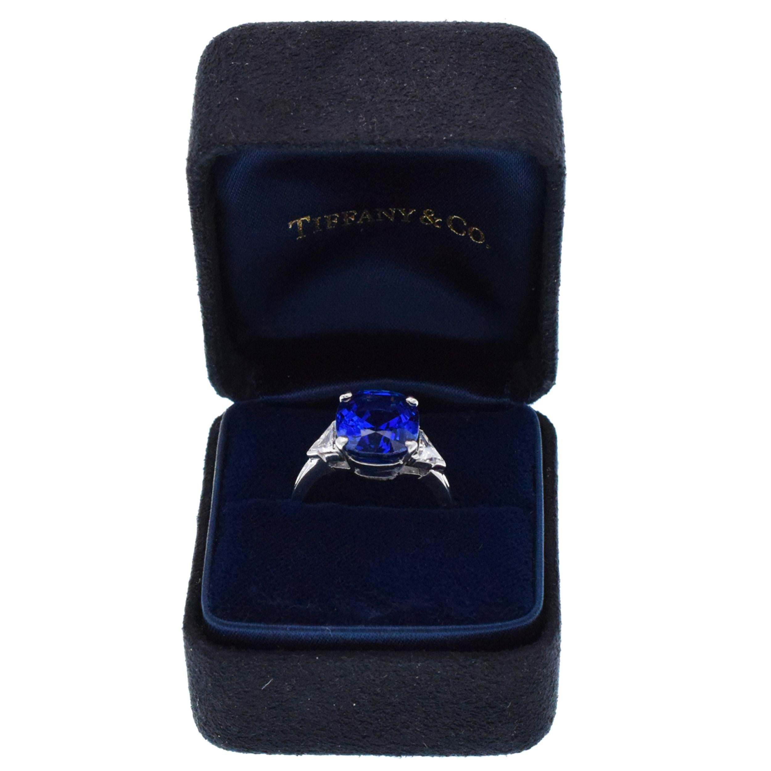 Tiffany & Co. Sapphire and diamond ring in platinum. The ring features three-stone design. Center of the
ring set with cushion cut Burma 