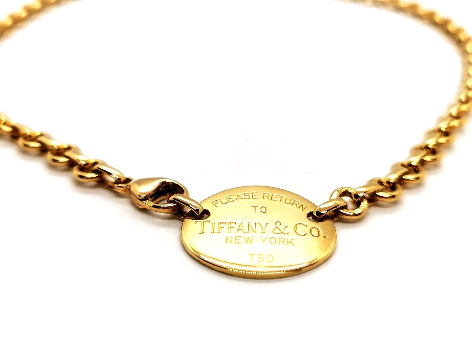 Collier signed by Tiffany & Co collection Return to Tiffany. yellow gold 750 thousandths (18 carats). wide flat belcher link chain. and domed oval plaque engraved: Please return to Tiffany & Co New York. length of the necklace: 40 cm chain width: