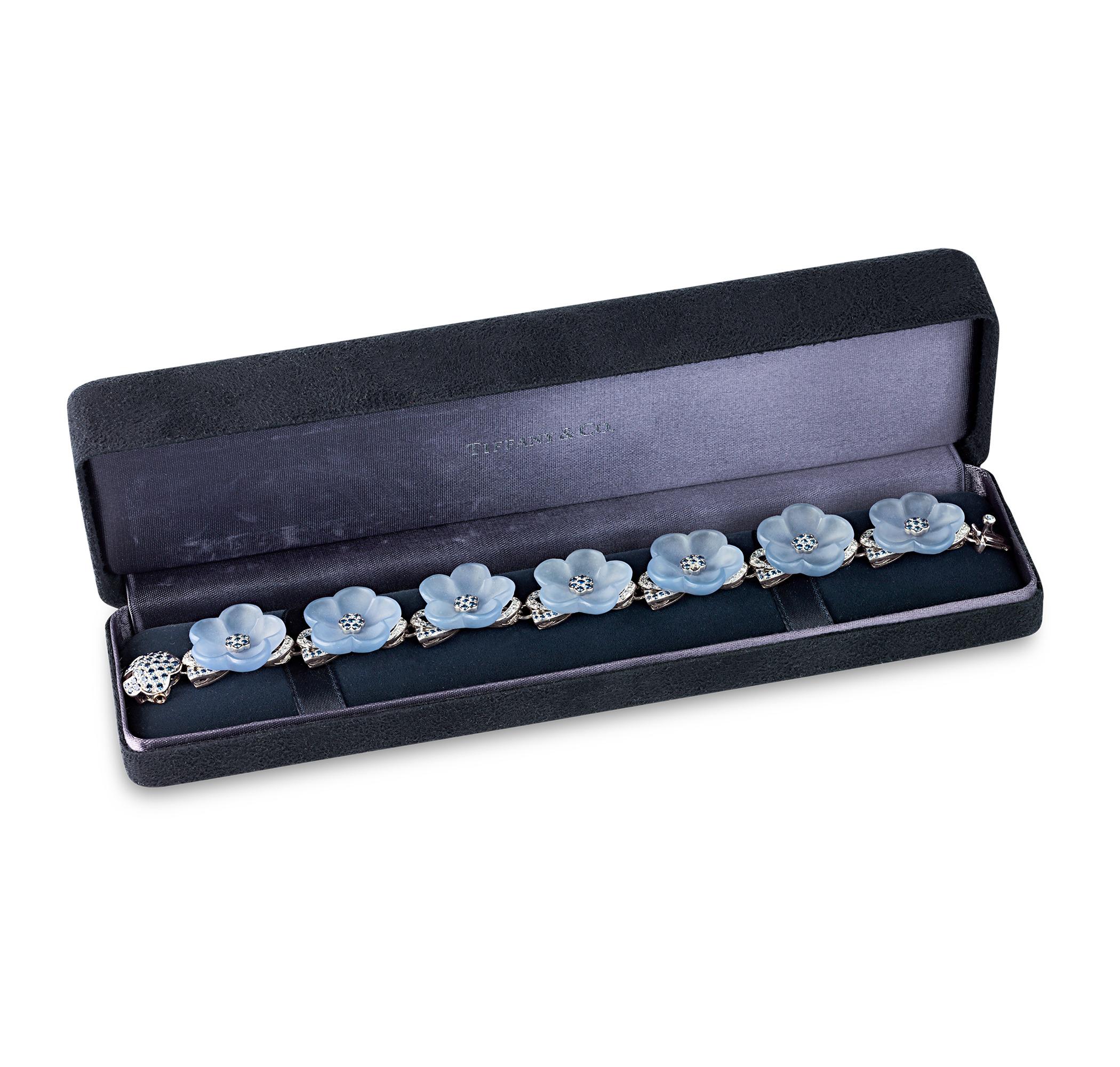 A delightful cascade of floral blooms, this glamorous bracelet epitomizes the craftsmanship for which Tiffany & Co. is so celebrated. Featuring delicately carved blue chalcedony petals, each flower is centered with sparkling blue sapphires. The