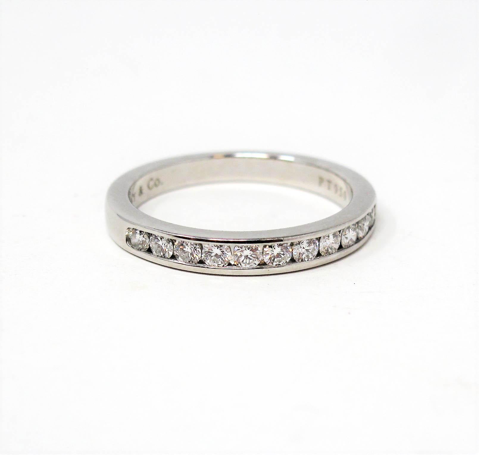 Stunning Tiffany & Co. diamond semi eternity band ring. This timeless beauty features icy white round diamonds channel set in a single elegant row. The sleek polished band has a modern, yet feminine feel. It would be perfect paired with an