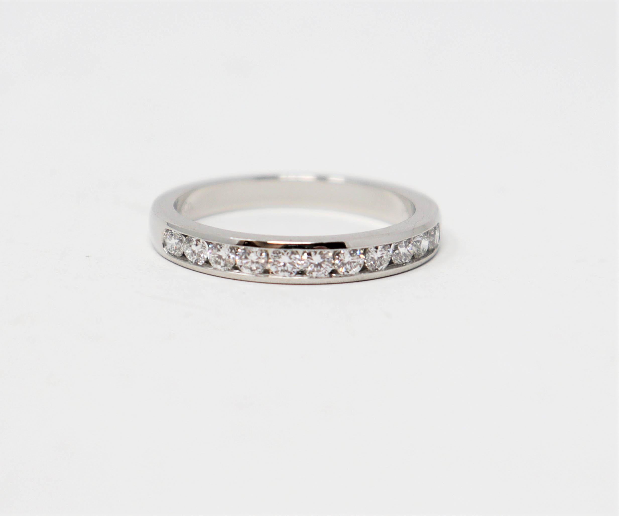 Ring size: 7

Stunning Tiffany & Co. diamond semi eternity band ring. This timeless beauty features icy white round diamonds channel set in a single elegant row. The sleek polished band has a modern, yet feminine feel. It would be perfect paired