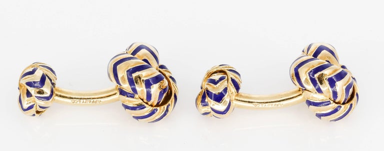 Fine pair of 18K yellow gold and chevron pattern blue enamel knot cufflinks by Tiffany & Co. Beautifully made and easy to wear.  

Hallmarks: Tiffany & Co., 750.