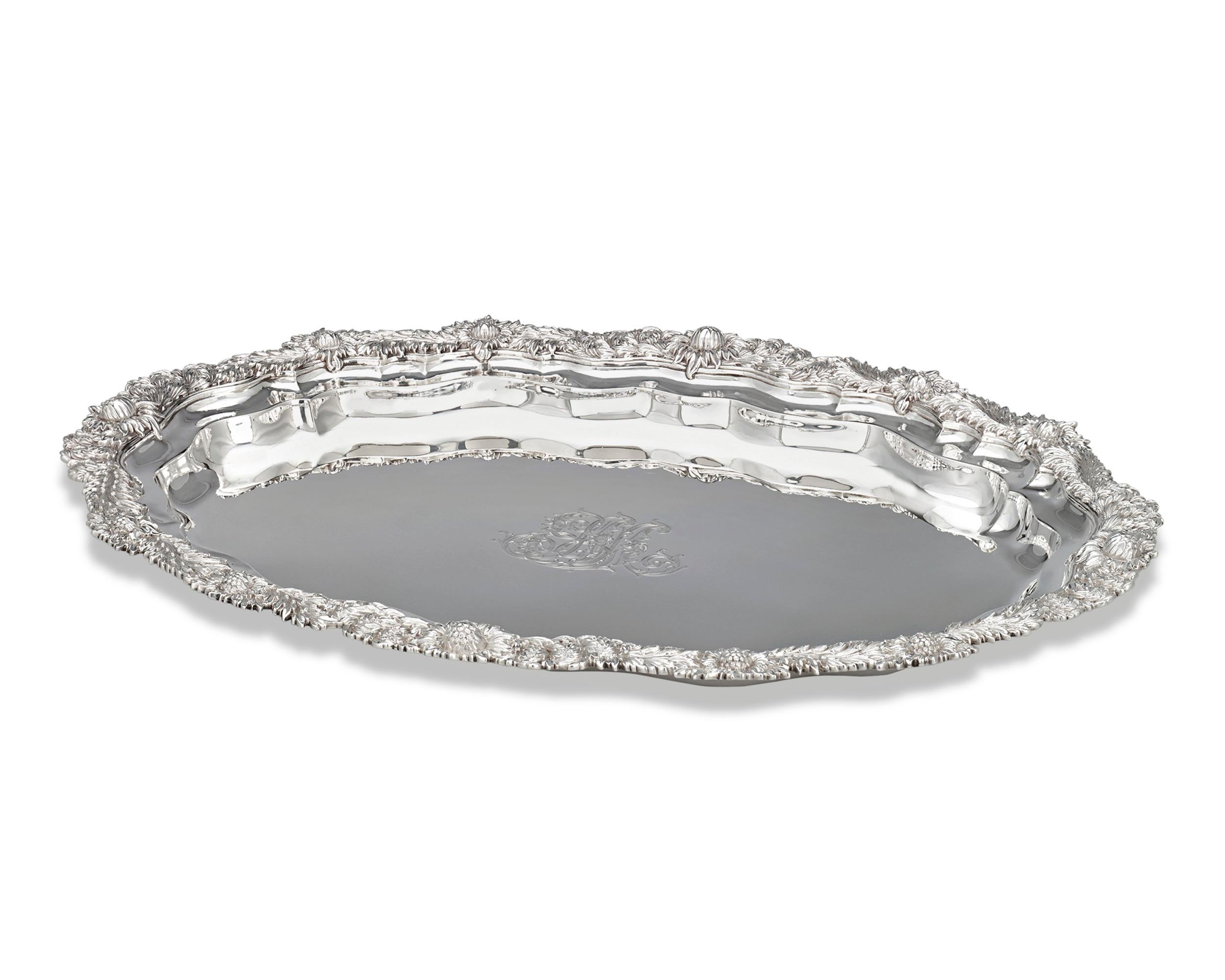 This exuberant silver tray was crafted by the incomparable Tiffany & Co. in the widely recognized Chrysanthemum pattern and exhibits the finest level of American silver craftsmanship. The motif's namesake flowers are expertly chased and applied