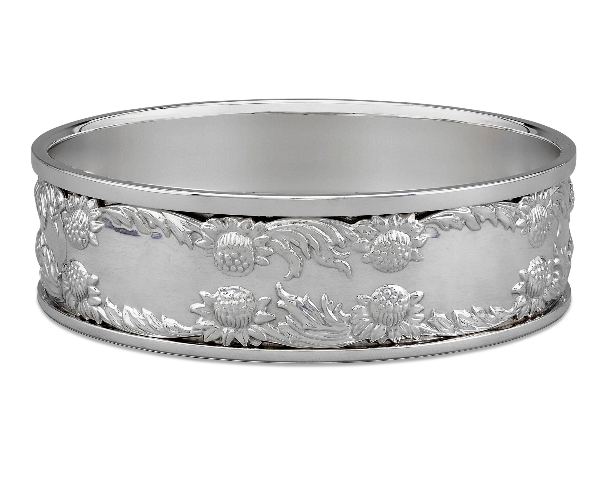 Large enough to fit a magnum-sized bottle of wine is this pair of exquisite sterling silver wine coasters by Tiffany & Co. Their elegant forms are adorned in the blooms of the Chrysanthemum pattern, perhaps Tiffany's most iconic and treasured silver