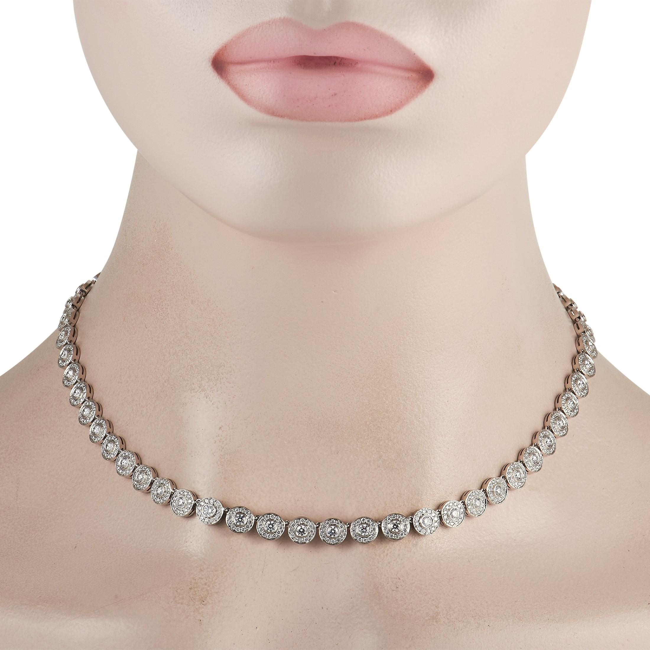 From Tiffany & Co.'s Circlet collection is this gorgeous necklace with a sparkling circle motif. It features a 16.5 inches long series of discs, each adorned with a single brilliant-cut diamond at the center. Surrounding each center diamond on each