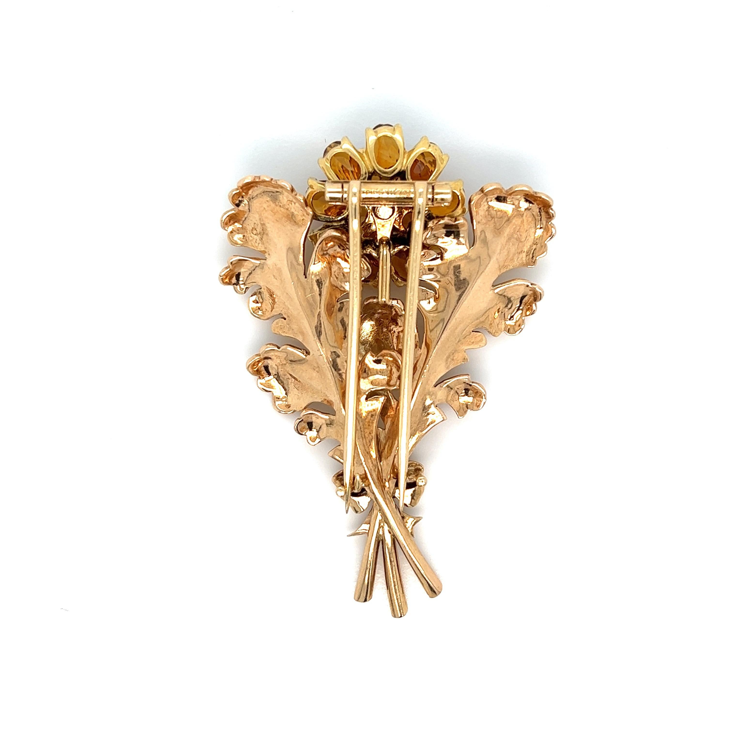 Tiffany & Co. yellow gold brooch with flower and leaves motifs. The flower's petals are made out of citrine and at its center is a round diamond weighing approximately 0.6 carat. Marked: Tiffany & Co. Total weight: 22.2 grams. Width: 1.75 inch.