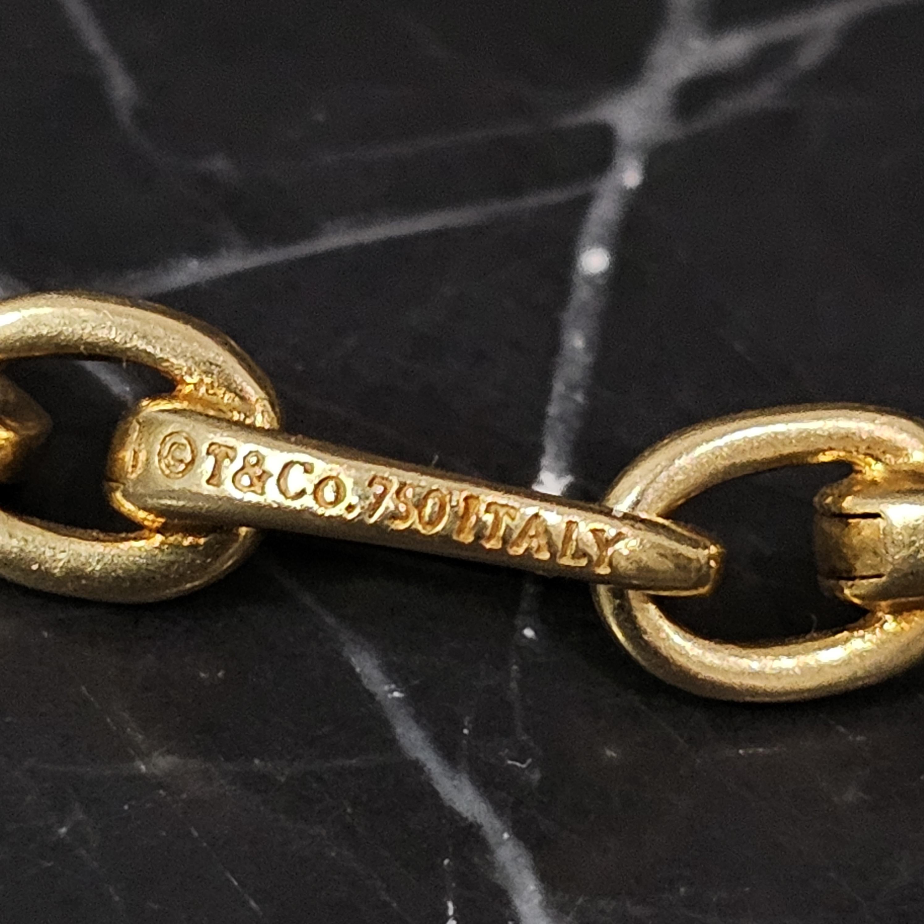 Tiffany & Co. Clasping Charm Bracelet Each Oval link Opens 18k Yellow gold 7.5