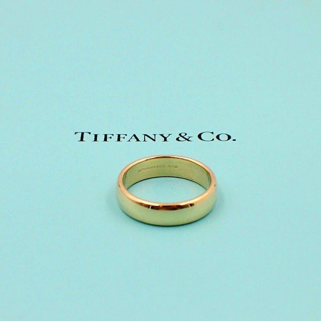 Tiffany & Co.
Style: Classic Wedding Band
SKU Number:  14768246
Metal:  18K Yellow Gold
Size:  10 - sizable  
Width:  6 MM 
Gold:  9.4 Grams 
Hallmark:  ©TIFFANY&CO.AU750
Includes:  T&C Jewelry Pouch

Retail Value:  $1,275 + tax = $1,373.81