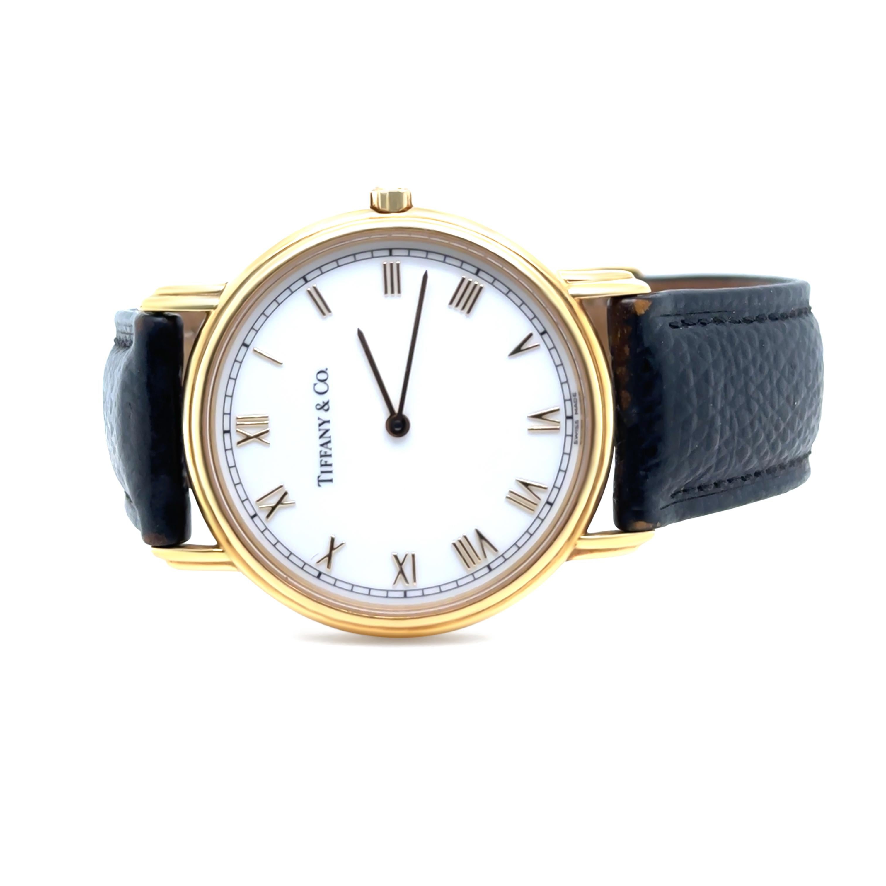 This elegant Tiffany & Co. Classic unisex watch is crafted in 18ct yellow gold, offering timeless sophistication and refined craftsmanship. The watch features a quartz movement for precision and reliability, with a case diameter of approximately
