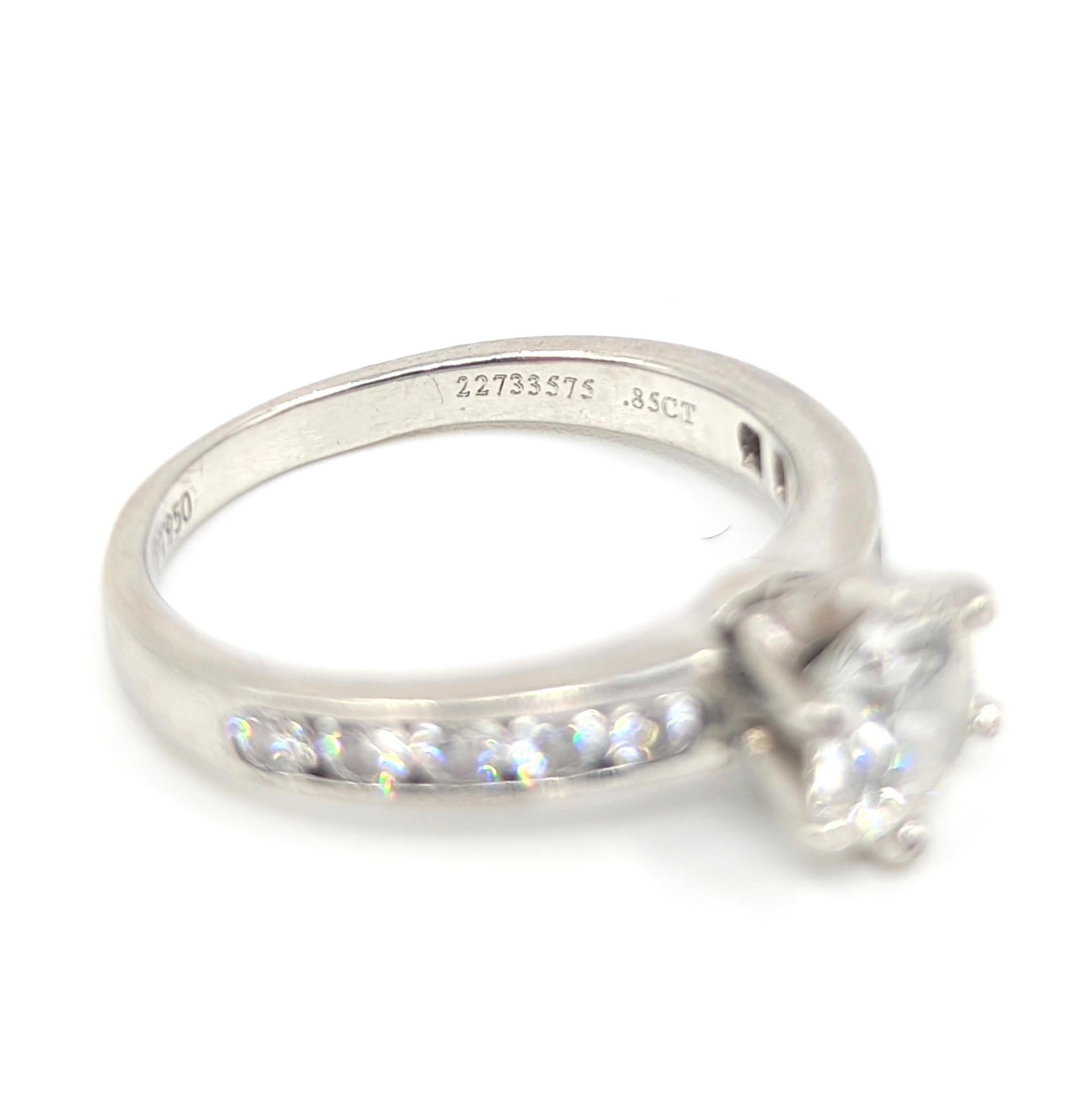 Tiffany & Co. original classic platinum diamond engagement ring, with a 0.85 CT (H, VS1, 3E) center diamond that is full of sparkles, and 10 brilliant round diamonds channel set in the shanks totalling approx 0.3 CT for total diamond weight of 1.15