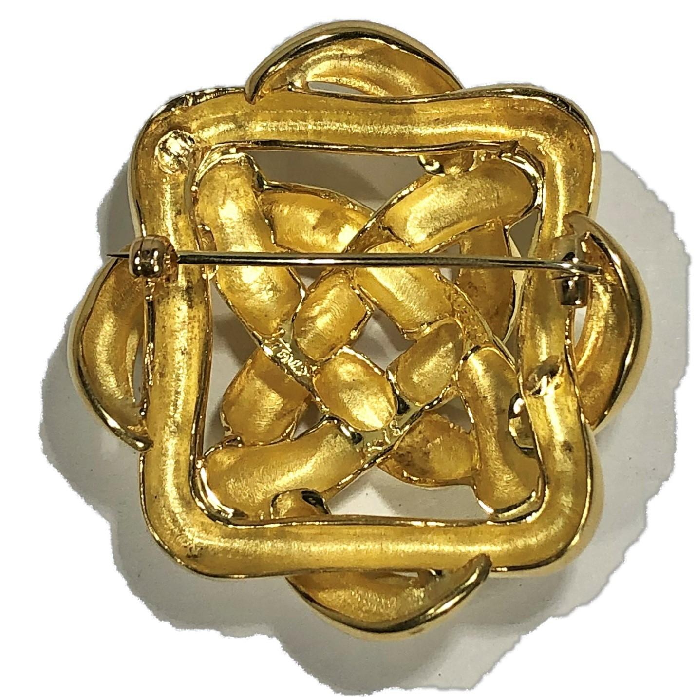 A classic 18K yellow gold, woven design brooch by Tiffany. The high polish,
geometric outline measures 1 3/4 inches long by 1 5/8 inches wide. Signed 
Tiffany 18K ITALY.  Gross weight 30.1 grams.