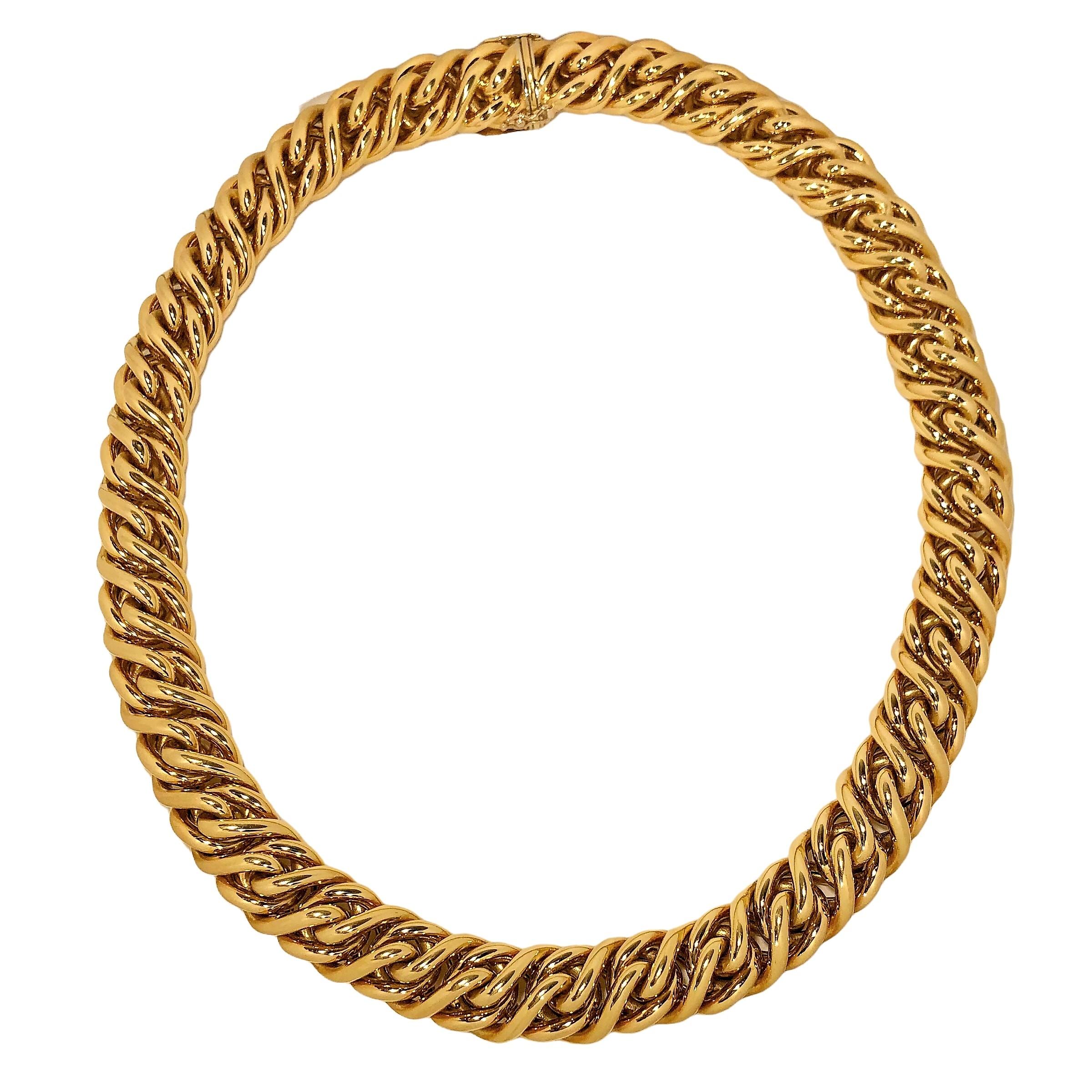This lovely vintage Tiffany & Company Italian 18K yellow gold necklace consists of one continuous run of braided, heavy gauge 18k tubing. It is quite wide, measuring 9/16 inches in width and is very dimensional, with a height of over 3/8 inches.