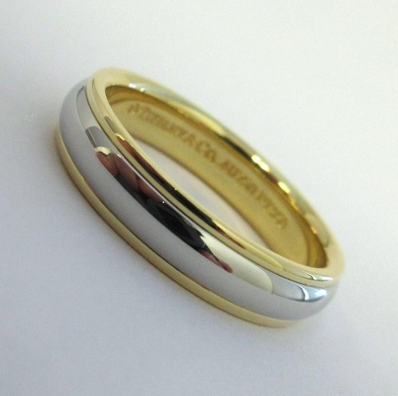 TIFFANY & Co. Classic Platinum 18K Yellow Gold 4mm Lucida Wedding Band Ring 5.5 

Metal: Platinum and 18K Yellow Gold
Size: 5.5 
Band Width: 4mm
Weight: 5.50 grams
Hallmark: ©TIFFANY&CO. AU750 PT950
Condition: Like new

Limited edition, no longer