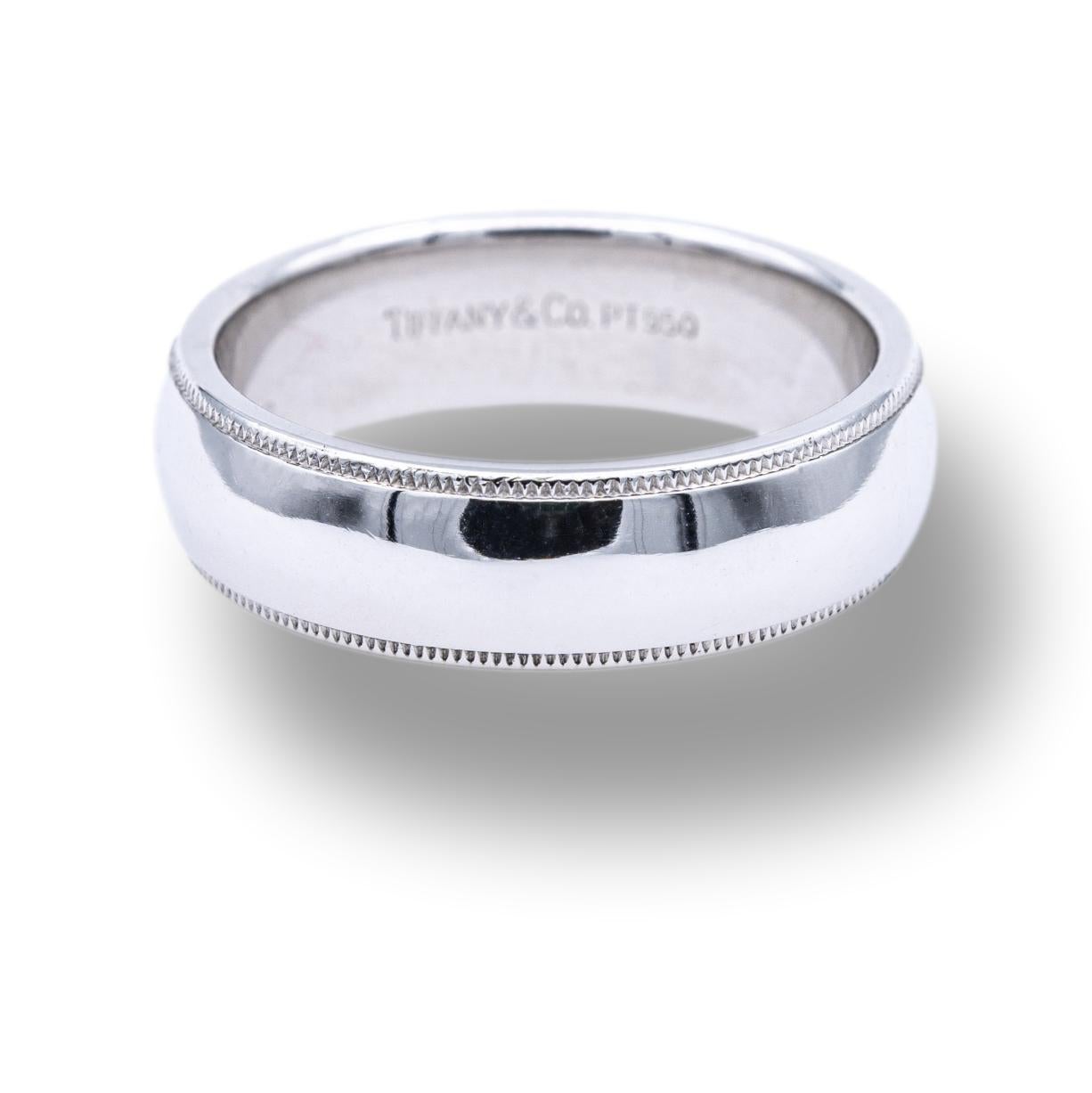 Tiffany & Co Classic Mens wedding band ring finely crafted in platinum with a mill grain edge and high polish finish. The band is comfort fit ,measures 6mm and weighs a hefty 14.3 grams. Size 9

Stamp ©Tiffany & Co. PT950
Size 9
Weight 14.3