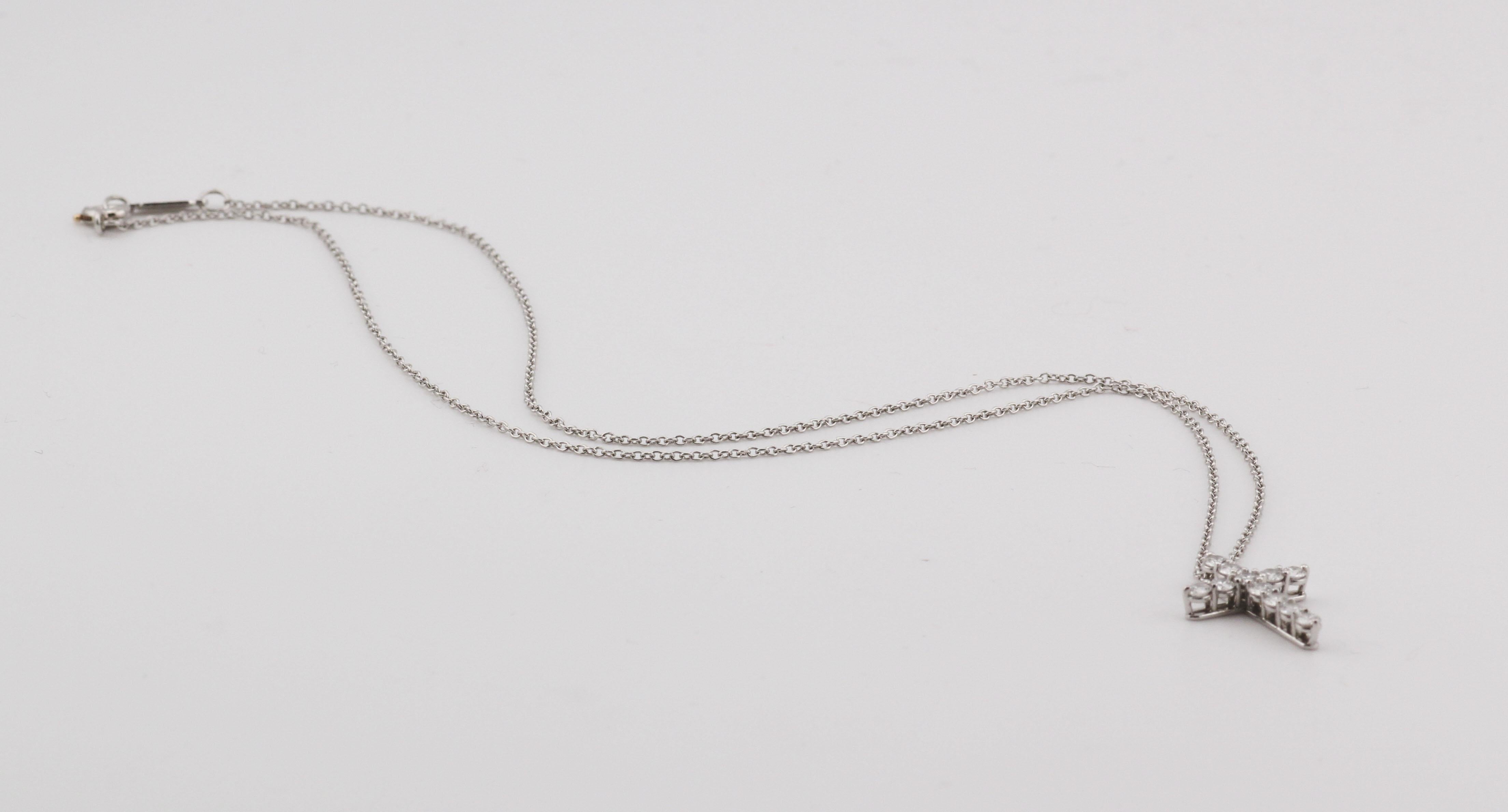 Timeless elegance meets spiritual grace in the Tiffany & Co. Classic Diamond Cross Pendant Necklace. Expertly crafted in luminous platinum, this refined piece showcases the House’s commitment to purity of design and exceptional craftsmanship.

The