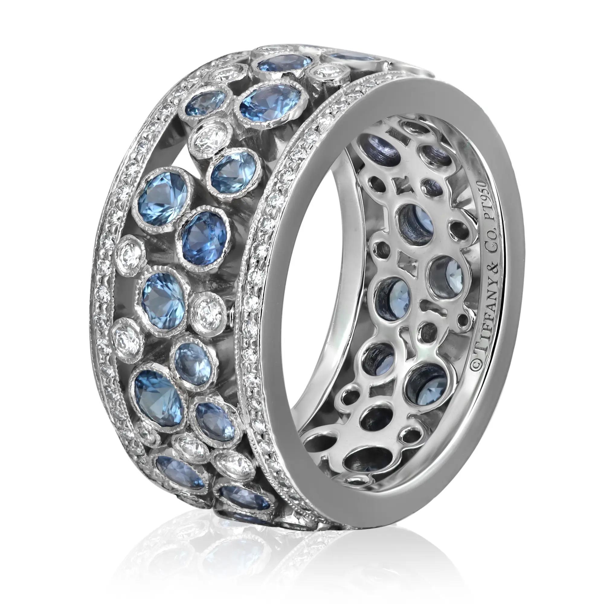 Stunning TIFFANY & Co. cobblestone band ring, crafted in fine lustrous platinum. The ring features round cut blue sapphires and round brilliant cut diamonds studded in bezel setting. Total diamond weight: 0.53 carat. Total blue sapphire weight: 1.99
