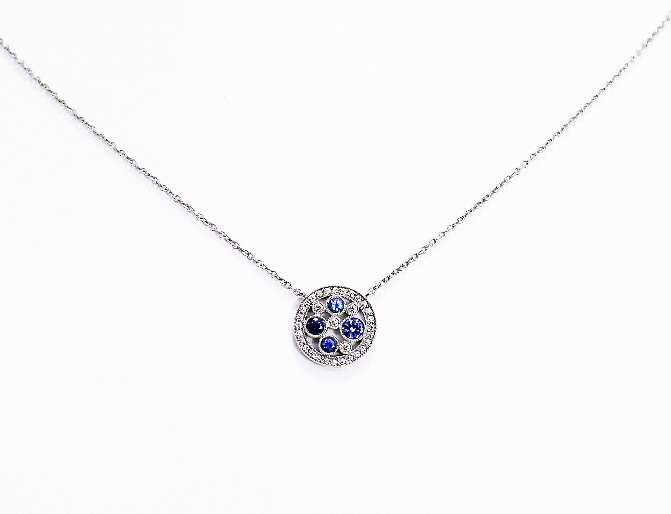 Tiffany & Co.'s Montana Sapphire Pendant from their Cobblestone Collection features four round blue sapphires and four round brilliant cut diamonds openly mounted in a rubover setting with a millgrain edge.  These stones are beautifully set in the