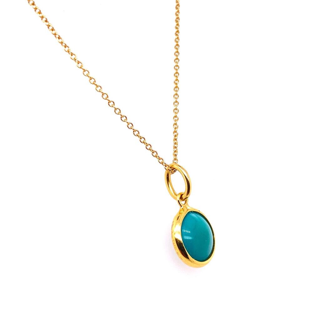 Tiffany & Co. Color By the Yard Turquoise Pendant Necklace. The 18 karat yellow gold necklace measures 16 inches in length and features a turquoise and gold round drop pendant. Signed Tiffany & Co. Au 750. Tiffany jewelry pouch included. 
MSRP: