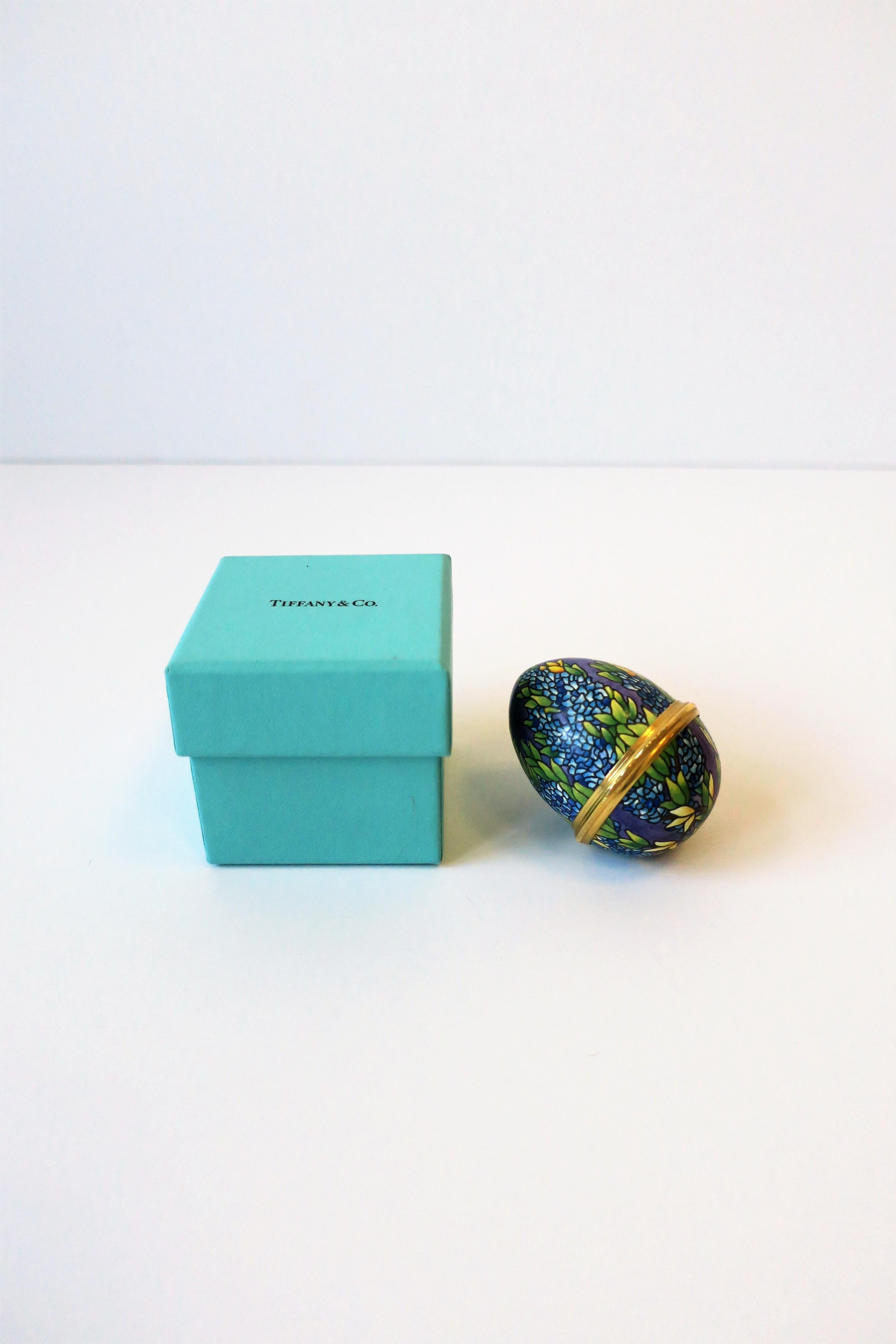 From luxury jewelry retailer Tiffany & Co., a beautiful colorful enamel 'Easter' egg box, circa 20th century. Tiffany & Co. egg box has a beautiful floral exterior supported by a gold-tone hinge; inside is marked 'Tiffany & Co.' as show in images #9