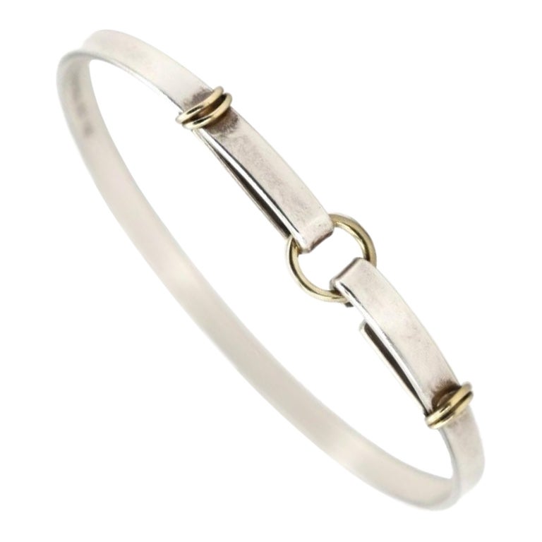 TIFFANY 
CO. Combi Hook Bangle Bracelet in 18k Yellow Gold 
Sterling Silver