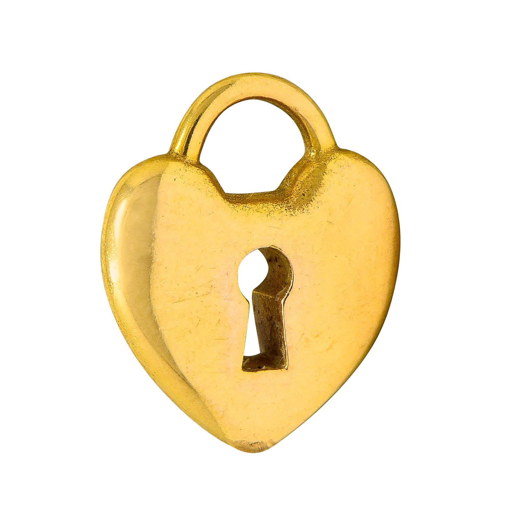 Charm is designed as a heart shaped padlock

With a pierced stylized keyhole center

Signed T & Co. and stamped 750 for 18 karat gold

From the Tiffany Hearts collection

Circa: 2000s

Measures: 3/8 x 7/16 inch

Total weight: 1.7 grams

Dainty. Key