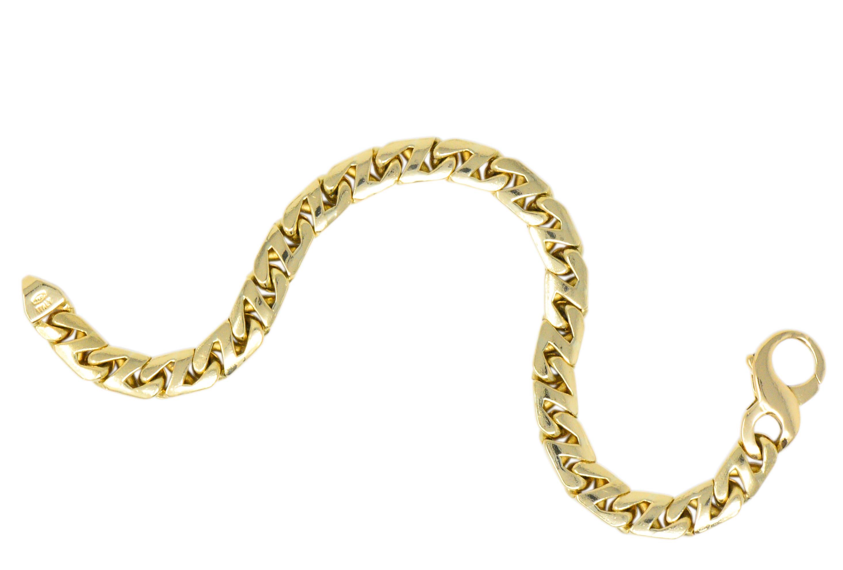 Cuban chain style link bracelet featuring a high polished finish

Completed by a stylized and oversized lobster clasp

Signed T & Co. Italy

Stamped 750 for 18 karat gold

Circa 1980

Length: 8 1/4 inches

Width: 5/16 inch

Total weight: 50.3