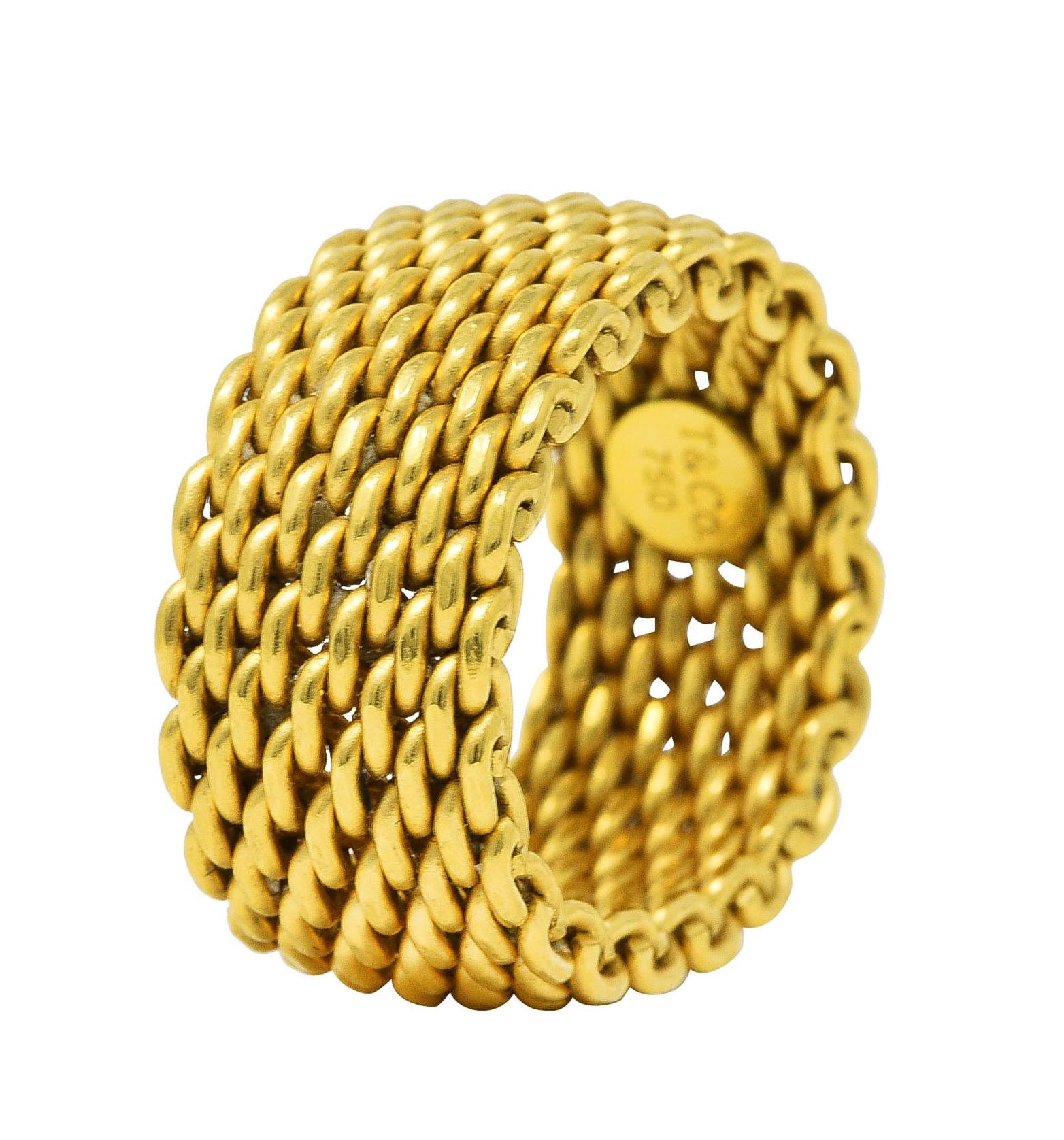 Ring is designed as flexible woven mesh fully around. With high polished gold finish. Stamped 750 for 18 karat gold. With maker's mark for Tiffany & Co. Circa: 21st century from the Somerset collection. Ring size: 7 and not sizable. Measures: North