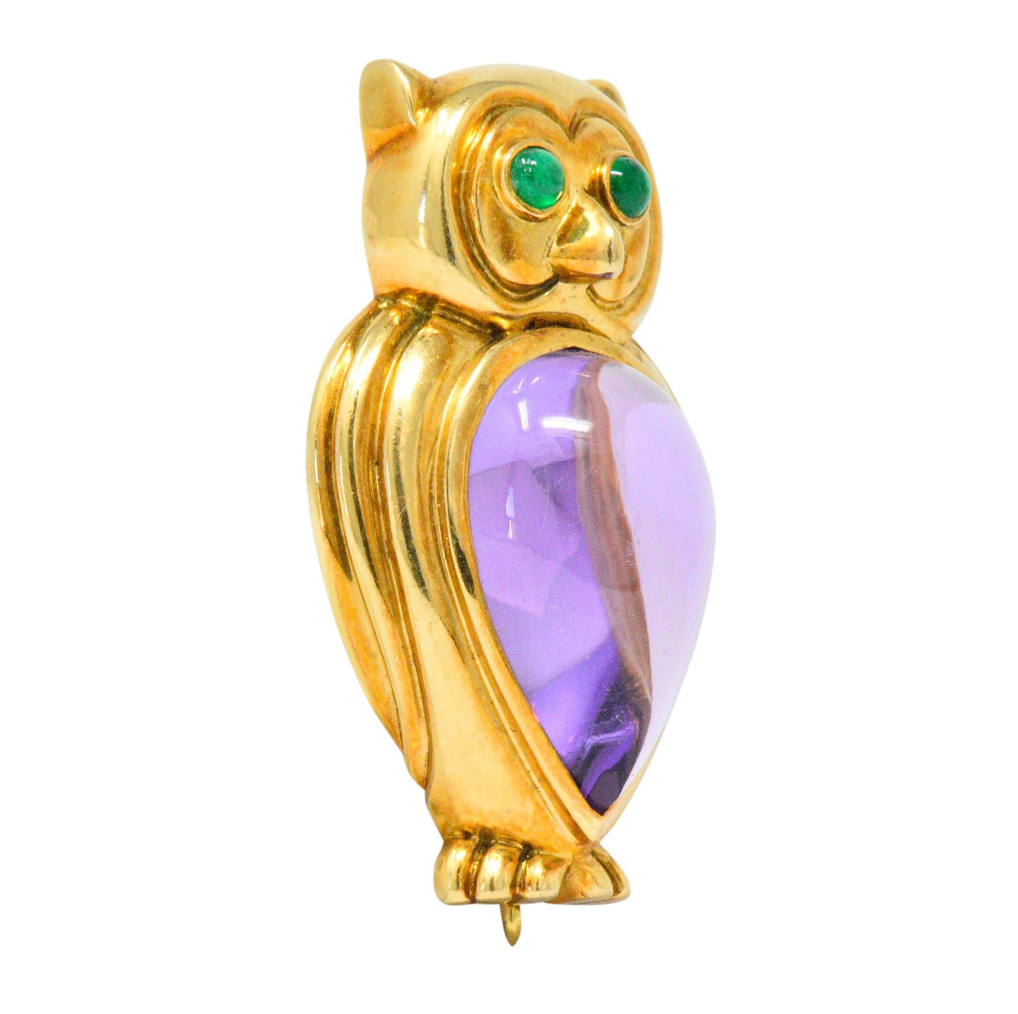 Featuring a dimensional owl design constructed of 18kt yellow gold

Centering a bezel set tear drop shaped cabochon amethyst measuring 18 mm x 11 mm

Round cabochon emerald eyes measuring 2 mm

Fully signed Tiffany & Co 1990 750

Measures 1 1/4