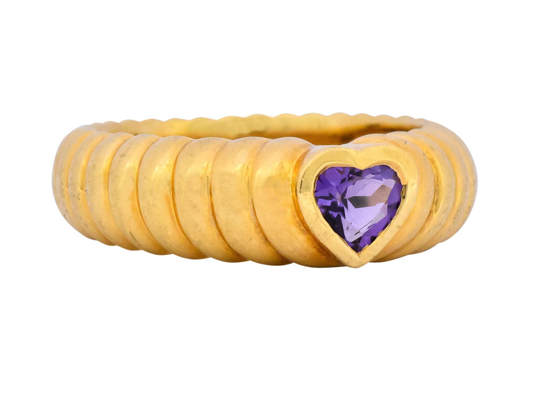 Centering a heart shaped amethyst, measuring approximately 5.2 x 5.3 mm, bright medium purple

Bezel set in high polished gold

With a polished fluted gold shank

Fully signed Tiffany & Co. and stamped 750 for 18 karat gold

Ring Size: 7 & not