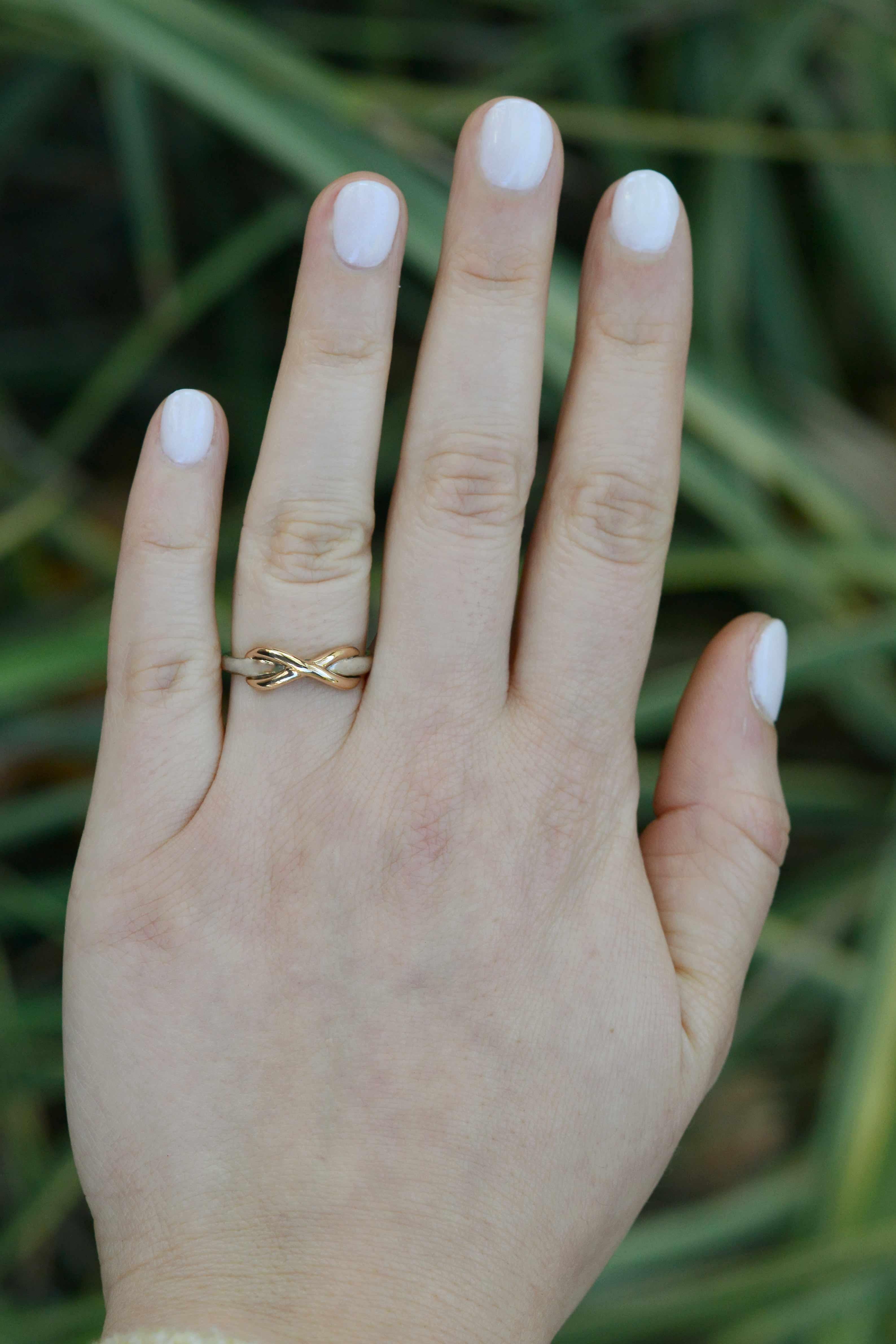 This Tiffany & Co. infinity band is a lovable little piece. This wedding band features a sterling silver band with a contrasting, intertwined 18k rose gold infinity woven through it. You can never go wrong with Tiffany! This retired design is no