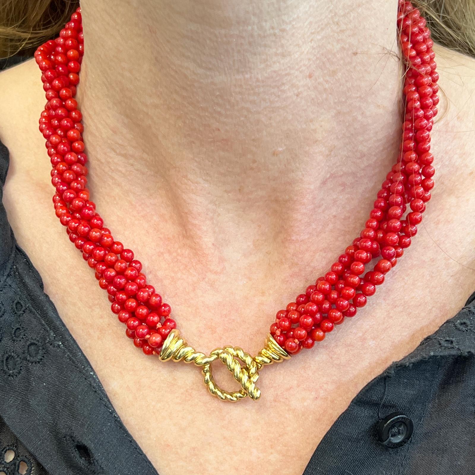 Stunning rare red coral multistrand necklace by Tiffany & Co. The necklace features 6 strands of matching  bright coral beads measuring 17 inches in length. The toggle clasp is fashioned in 18 karat yellow gold and signed Tiffany & Co. 18K. 