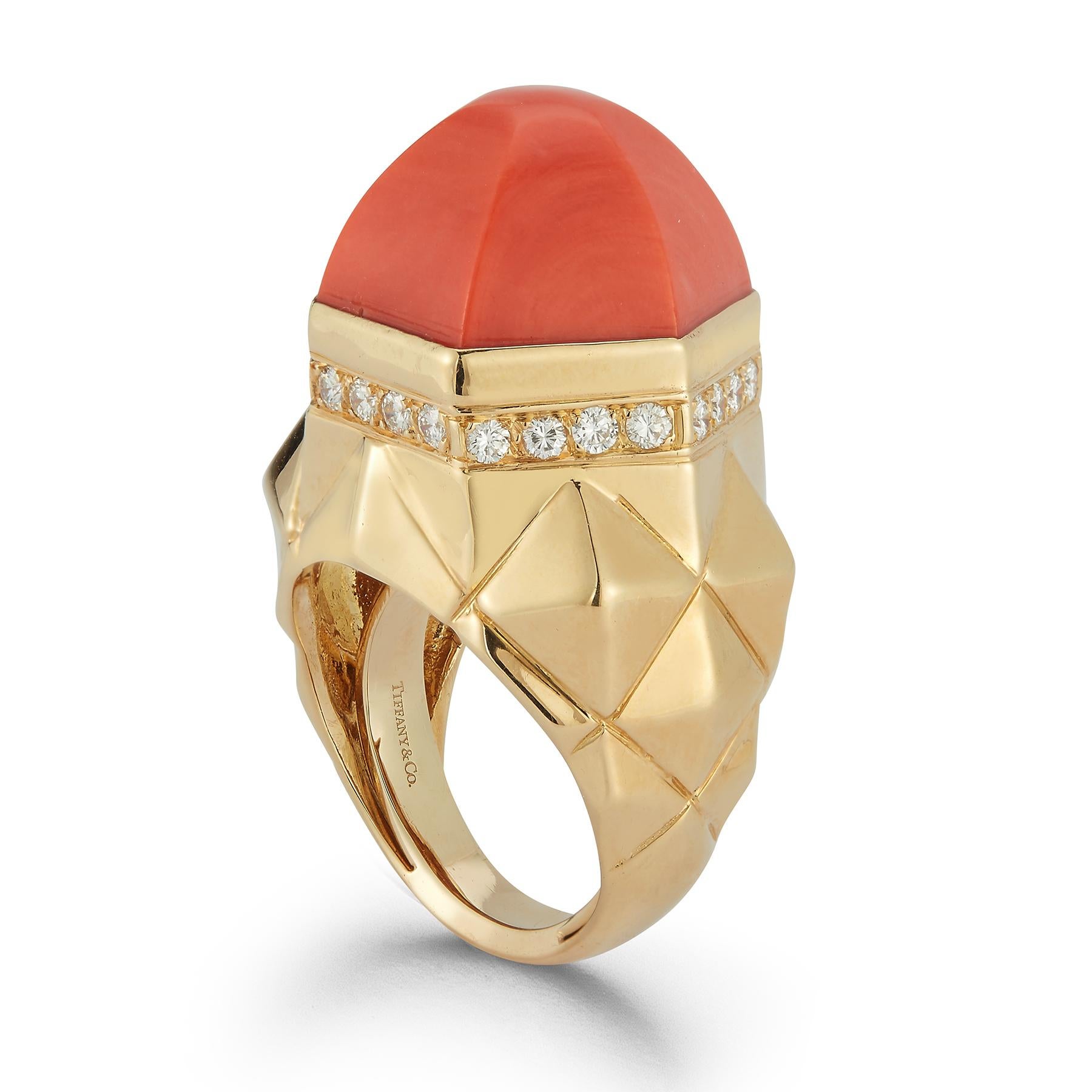 Tiffany & Co. Coral & Diamond Dome Ring

A bold and sophisticated Tiffany & Co. ring, crafted in 18k yellow gold and featuring a striking faceted coral centerpiece. The coral’s warm, reddish-orange hue is elegantly complemented by a row of sparkling