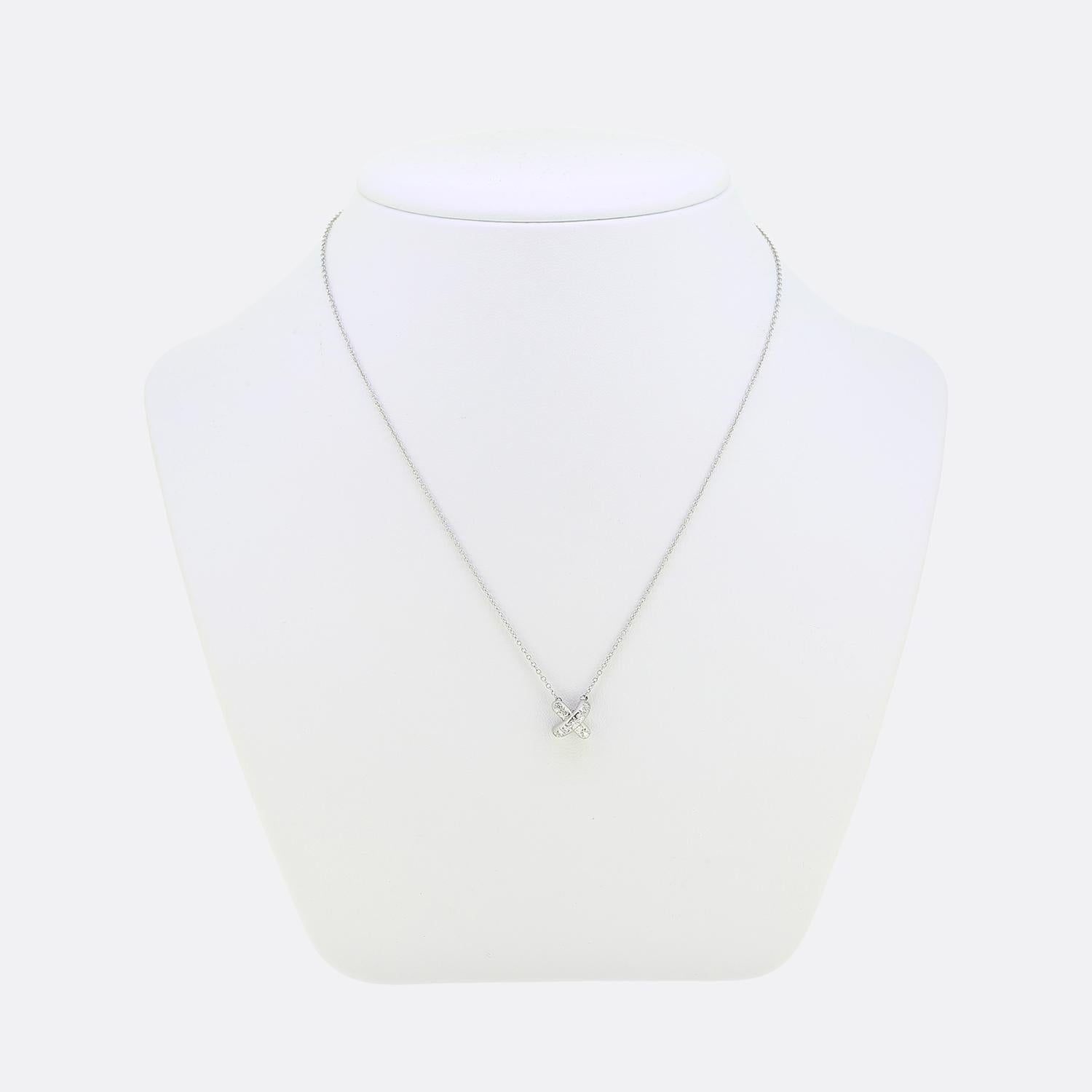 Here we have an iconic necklace from the world renowned jewellery designer, Tiffany & Co. This elegant piece has been crafted from platinum and presents an 'X' cross stitch pendant set with approximately 0.19 carats of round brilliant cut diamonds.