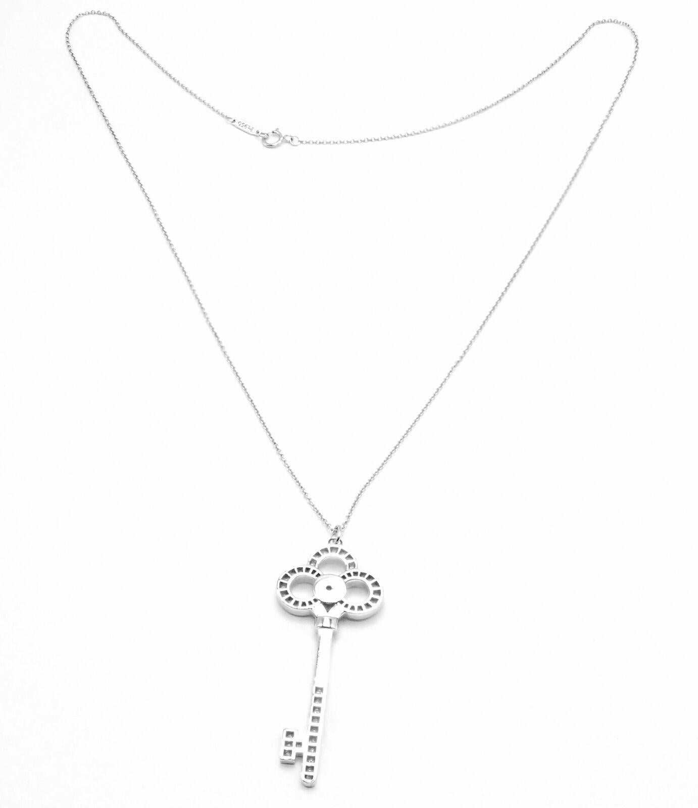 Platinum Diamond Crown Key Large Pendant Necklace by Tiffany & Co.
With 62 Round brilliant cut white diamonds total weigh approximately .64ct
Details:
Weight: 12.2 grams
Length: 20