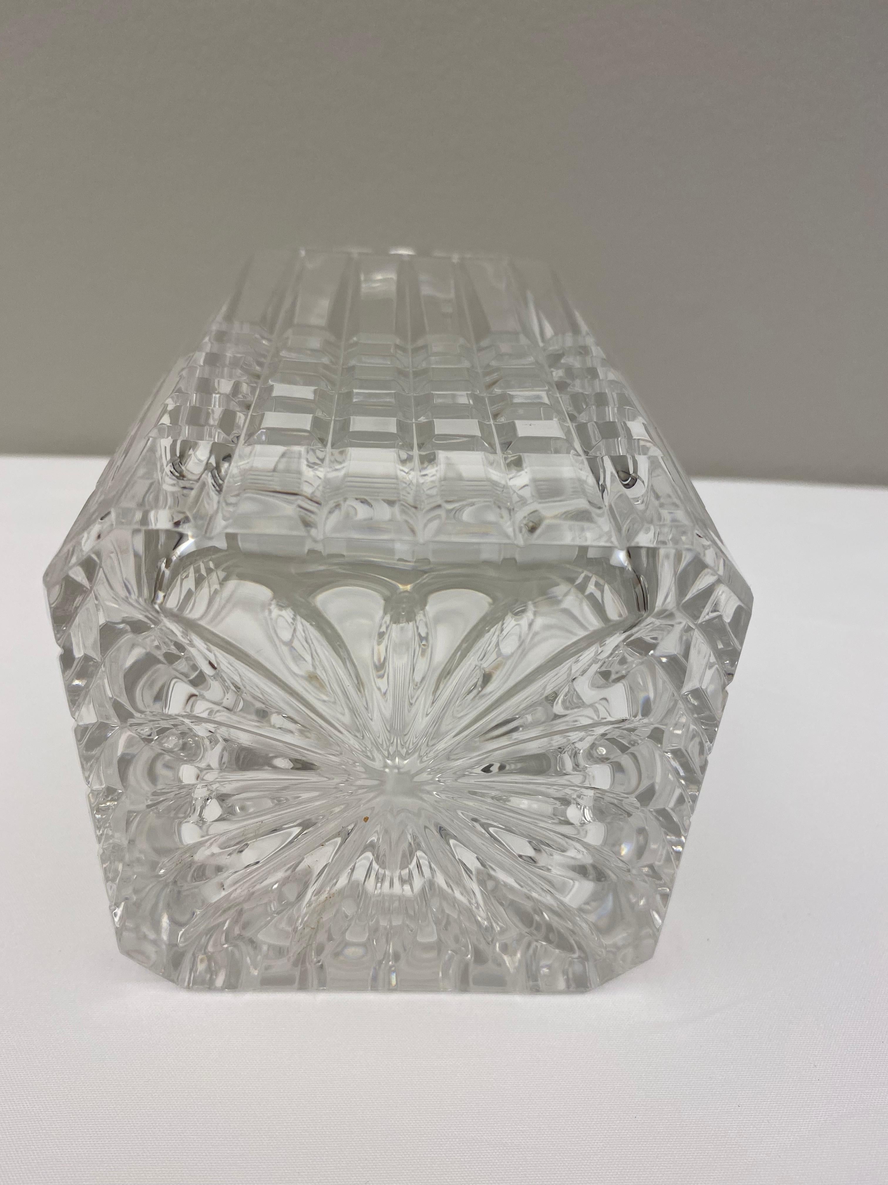 Crystal whiskey decanter by Tiffany and Co. Features a vertical arching lines on top of cubic cuts garnishing the lower half of the decanter. Finished with a spherical, faceted stopper. 

Marked: 