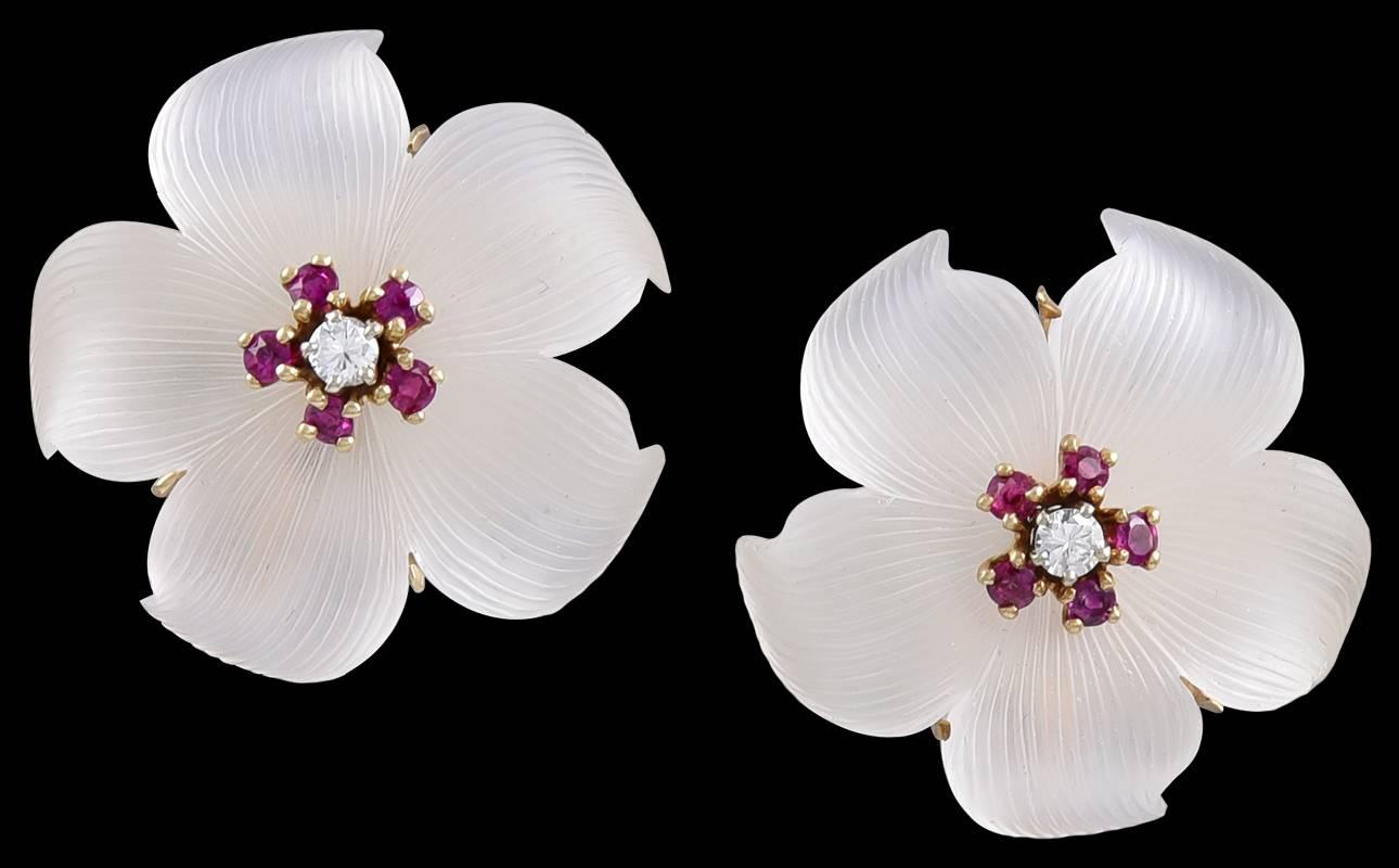 Beautiful and luminous carved crystal flower ear clips.  Made, signed and numbered by TIFFANY & CO.  Set with center diamonds, surrounded by brilliant cut rubies. 14K yellow gold. 1 1/4