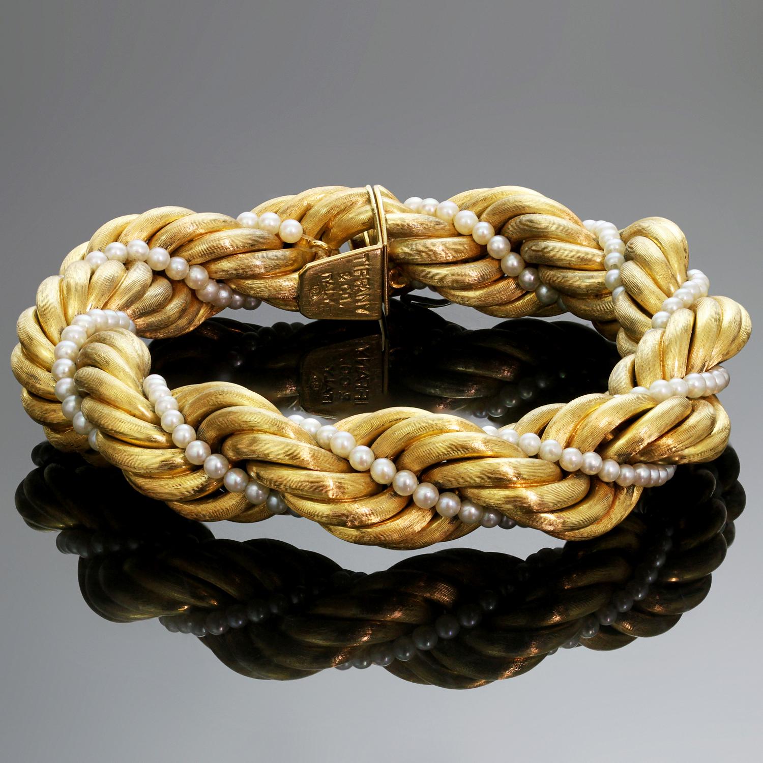 This exquisite vintage Tiffany bracelet features a gorgeous twisted rope design crafted in 18k brushed yellow gold and accented with a row of cultured pearls. Made in Italy circa 1960s. Measurements: 0.55