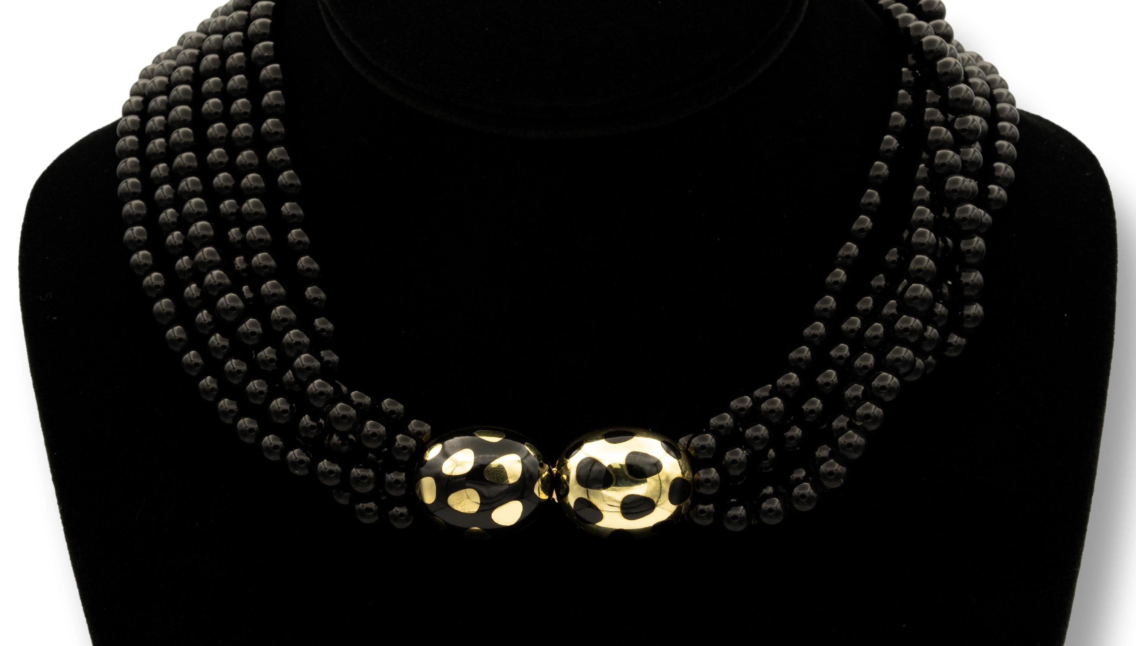 Tiffany & Co. Torsade necklace by Angela Cummings finely crafted in 18 karat yellow gold with multiple strands of 5.5-5.7mm black jade beads. The beads are held by positive/negative design with a push-down tongue clasp, embellished with multiple