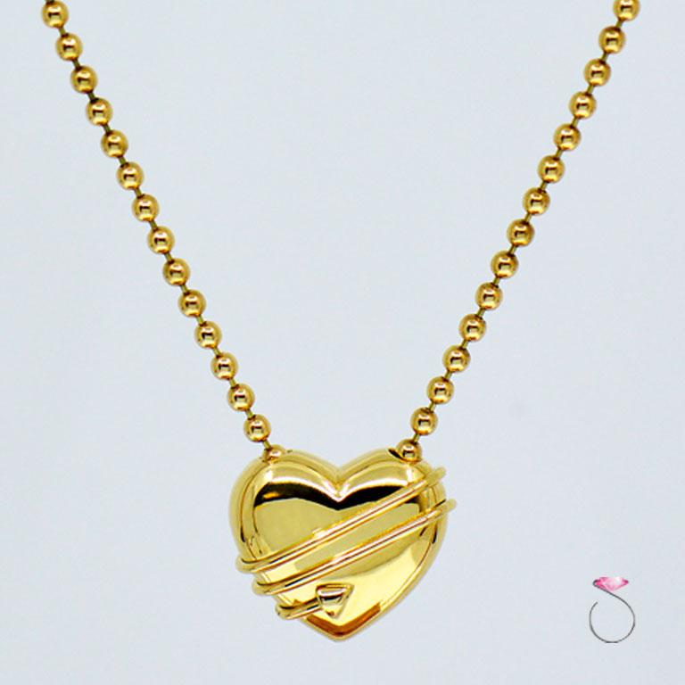 Authentic Tiffany & co. Cupid Heart & Arrow pendant with chain 18k yellow gold bead chain. The 18K yellow gold puff heart pendant measures approximately 19.60 mm x 16.70 mm x 9.75 mm. The pendant is attached to a beautiful 16 inch bead chain with a