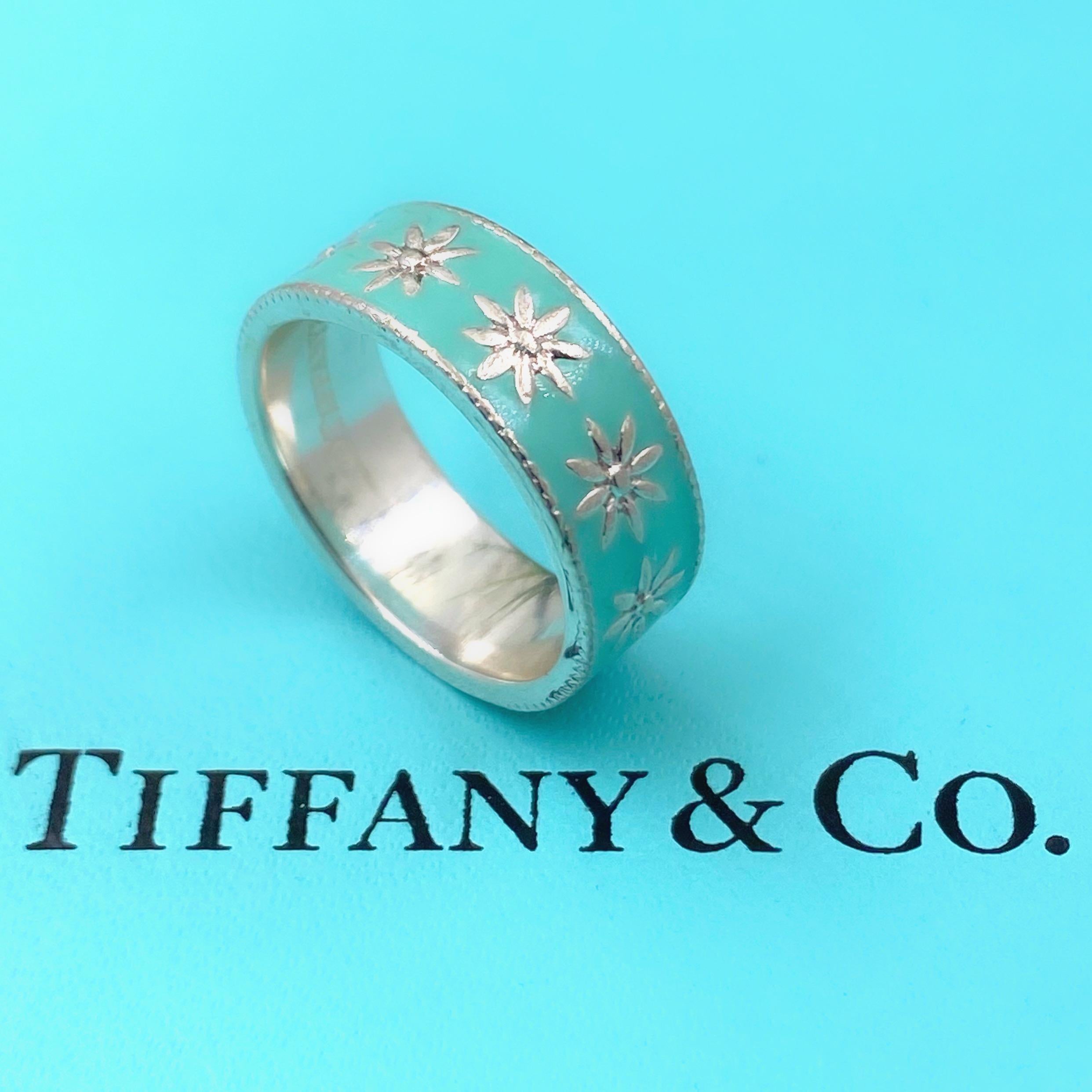 Tiffany & Co. Daisy Flower Ring
Style:  Band Ring
Metal:  Blue Enamel with Sterling Silver
Size:  5.75
Measurements:  10 MM Width
Hallmark:  ©TIFFANY&CO.AG925
Includes:  T&C Blue Box

Sku#1240TJK040119